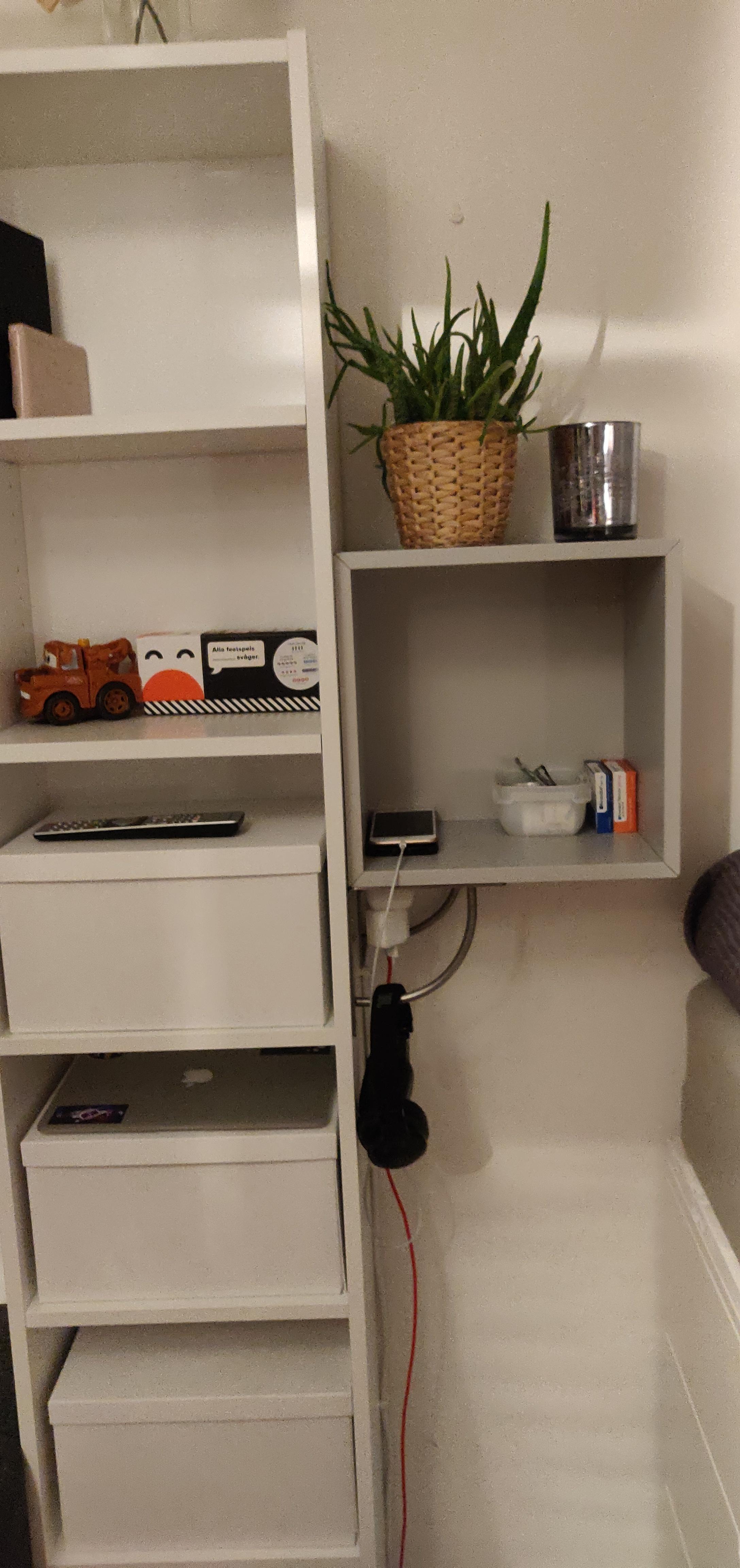 Eket cube hanging of the side of a Billy to avoid drilling in the wall