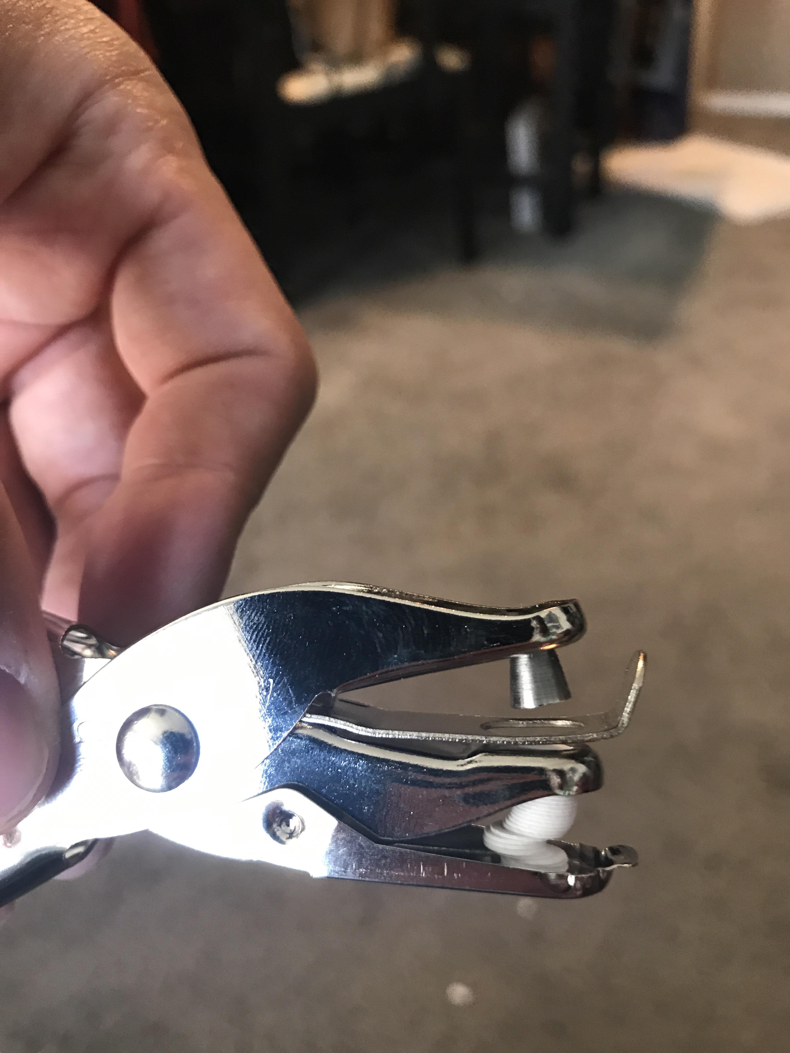 The paper nicely jammed in this hole puncher r/mildlyinteresting