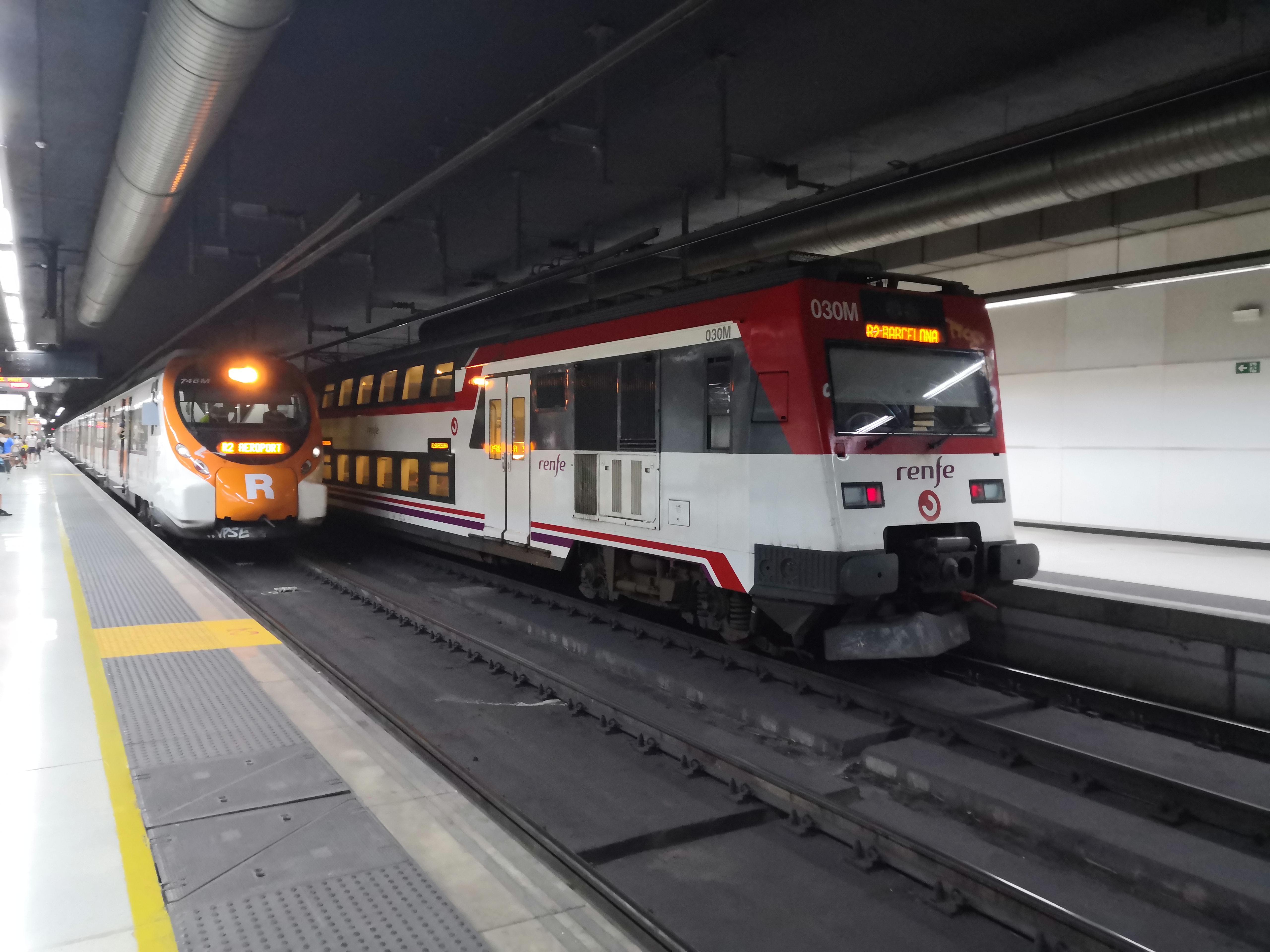 2 Renfe trains at Barcelona Sants Left Renfe 465 Civia Right