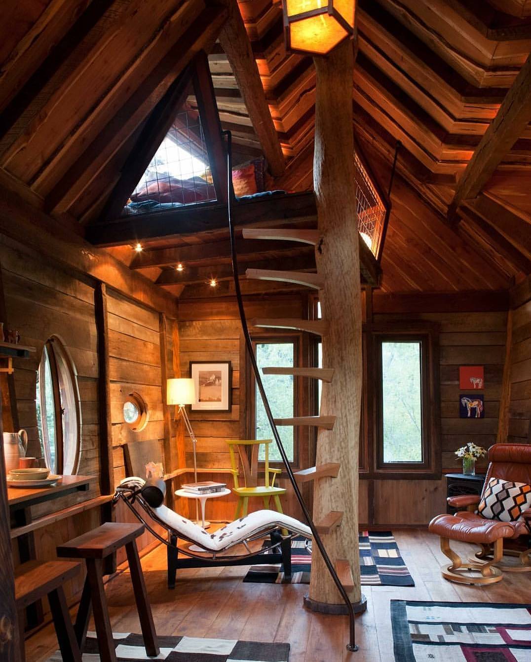 Tree house living area with a sleeping loft at the top of the stairs