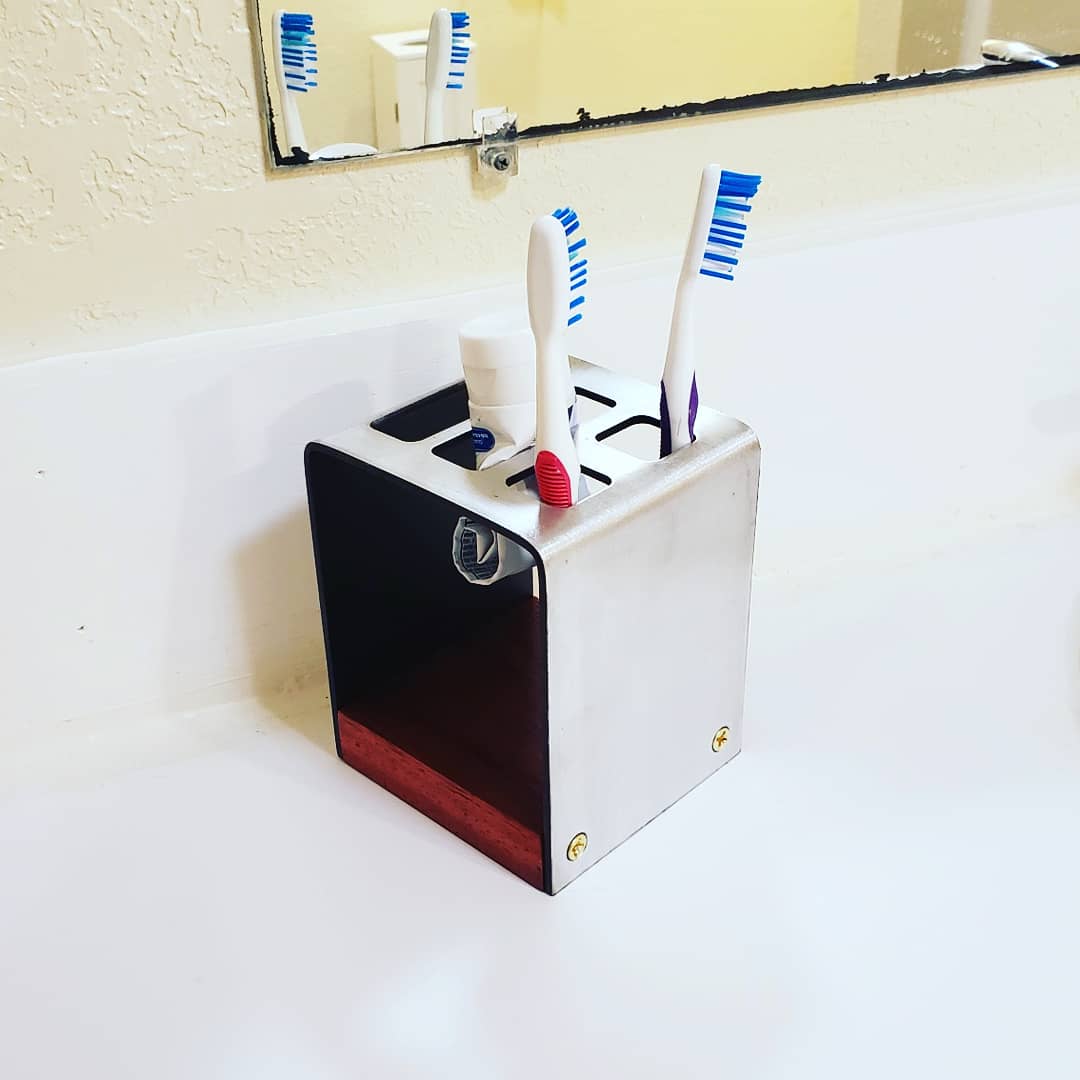 Made a toothbrush holder. Aluminum brass and padauk. r/metalworking