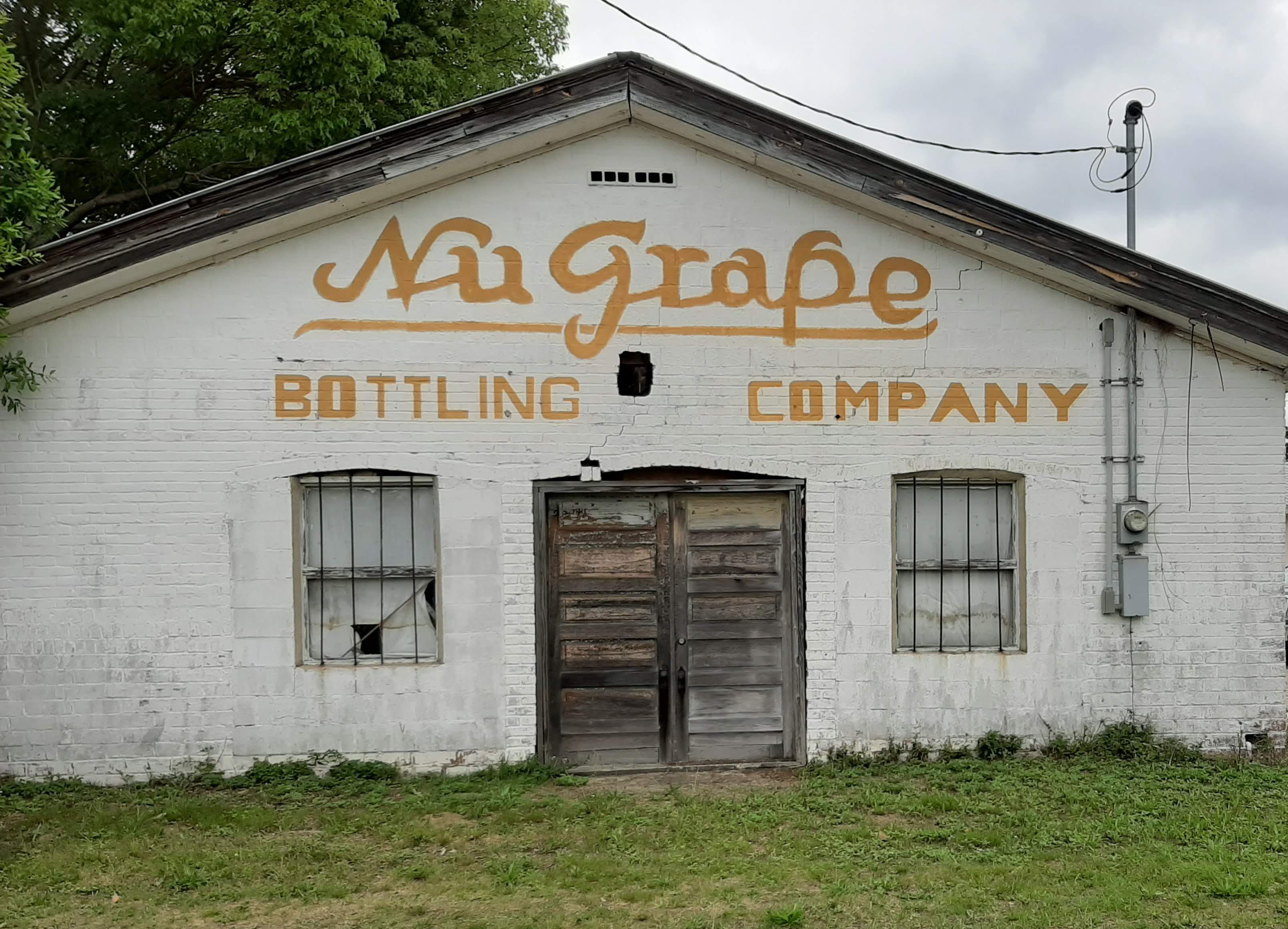 Old NuGrape bottling company. Building still used in back as an auto