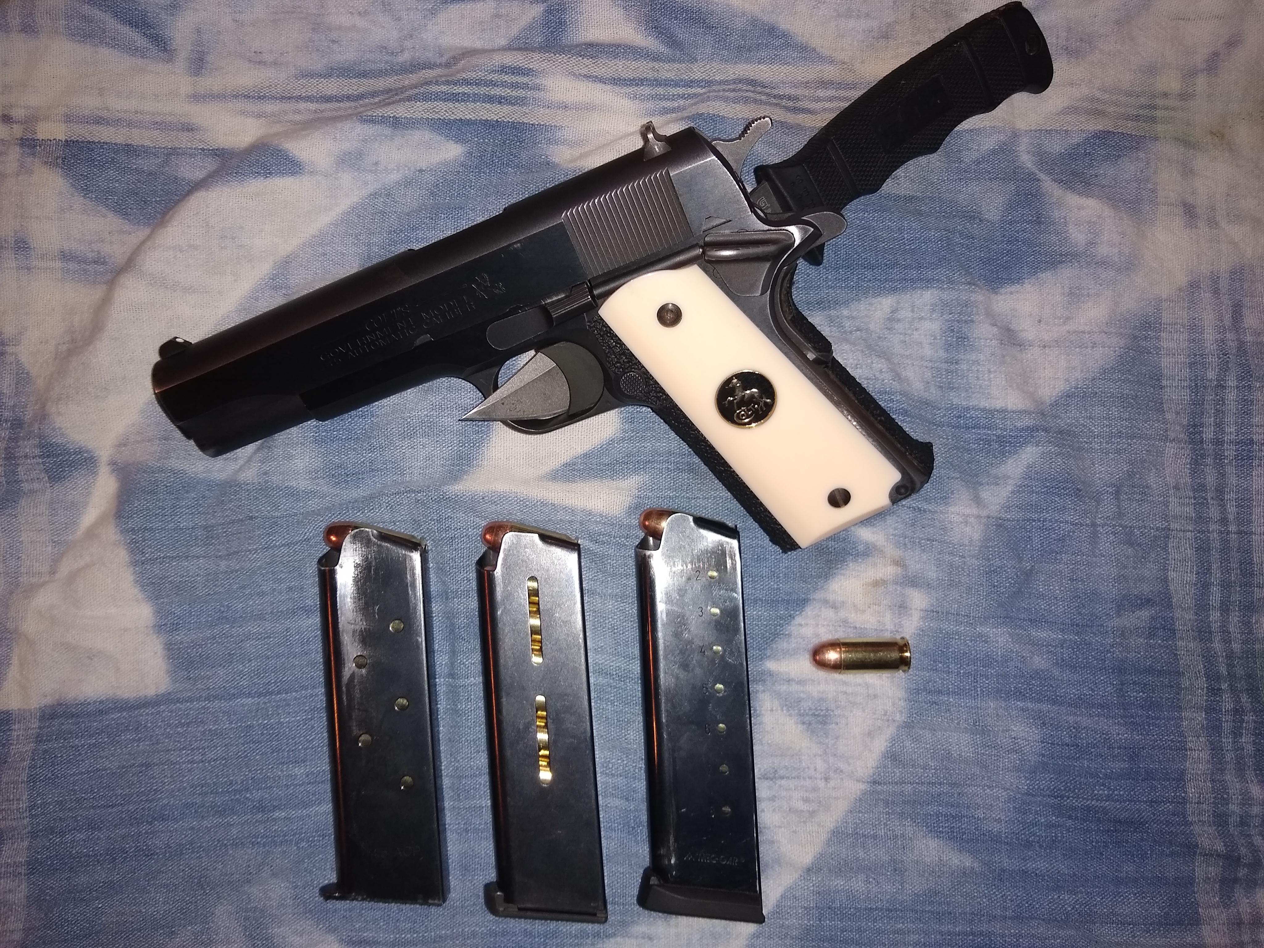 My final product, after about 900 rounds. Ivory grips and grip tape by Red Cat. No other