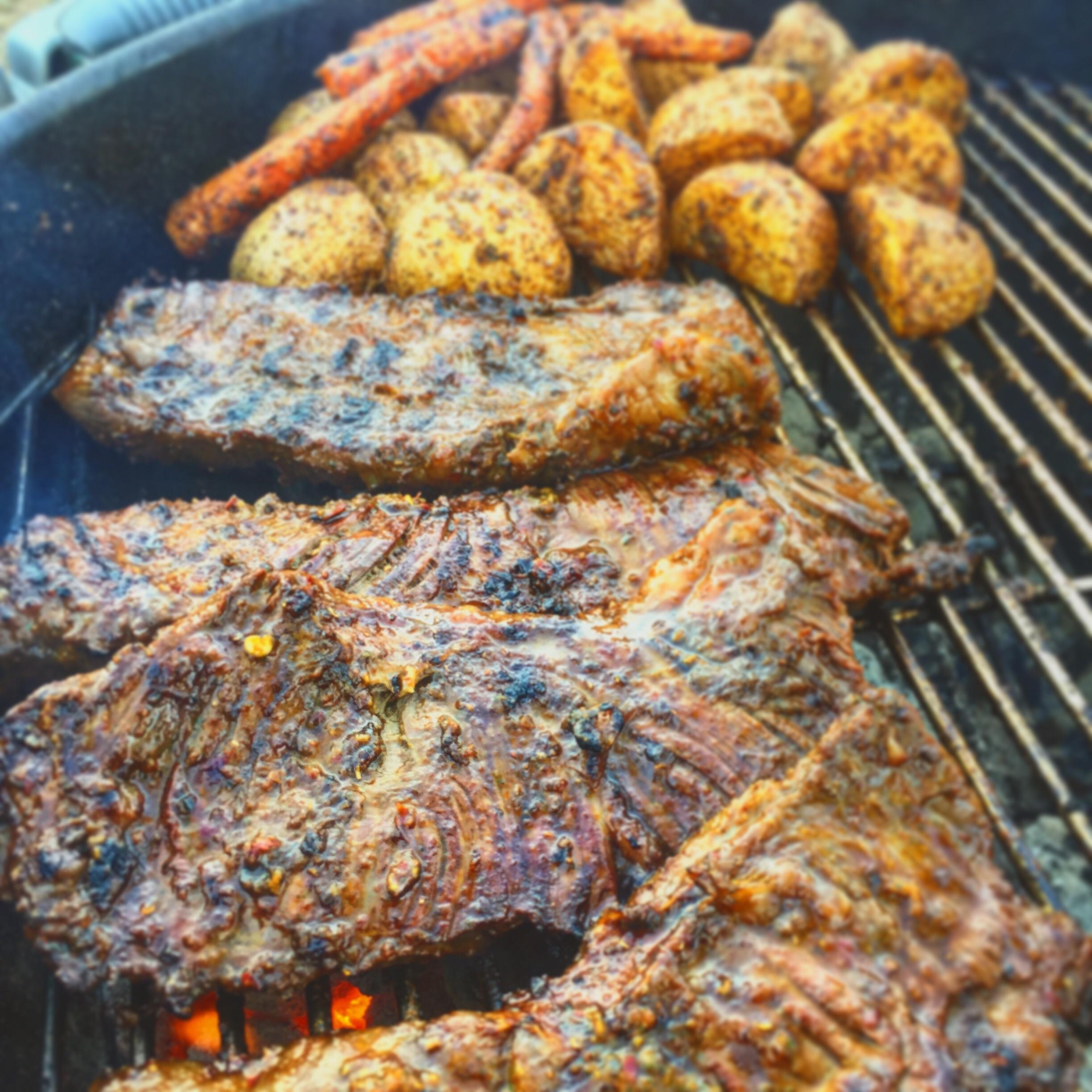 Skirt steaks and potatoes on the trusty er. r/grilling