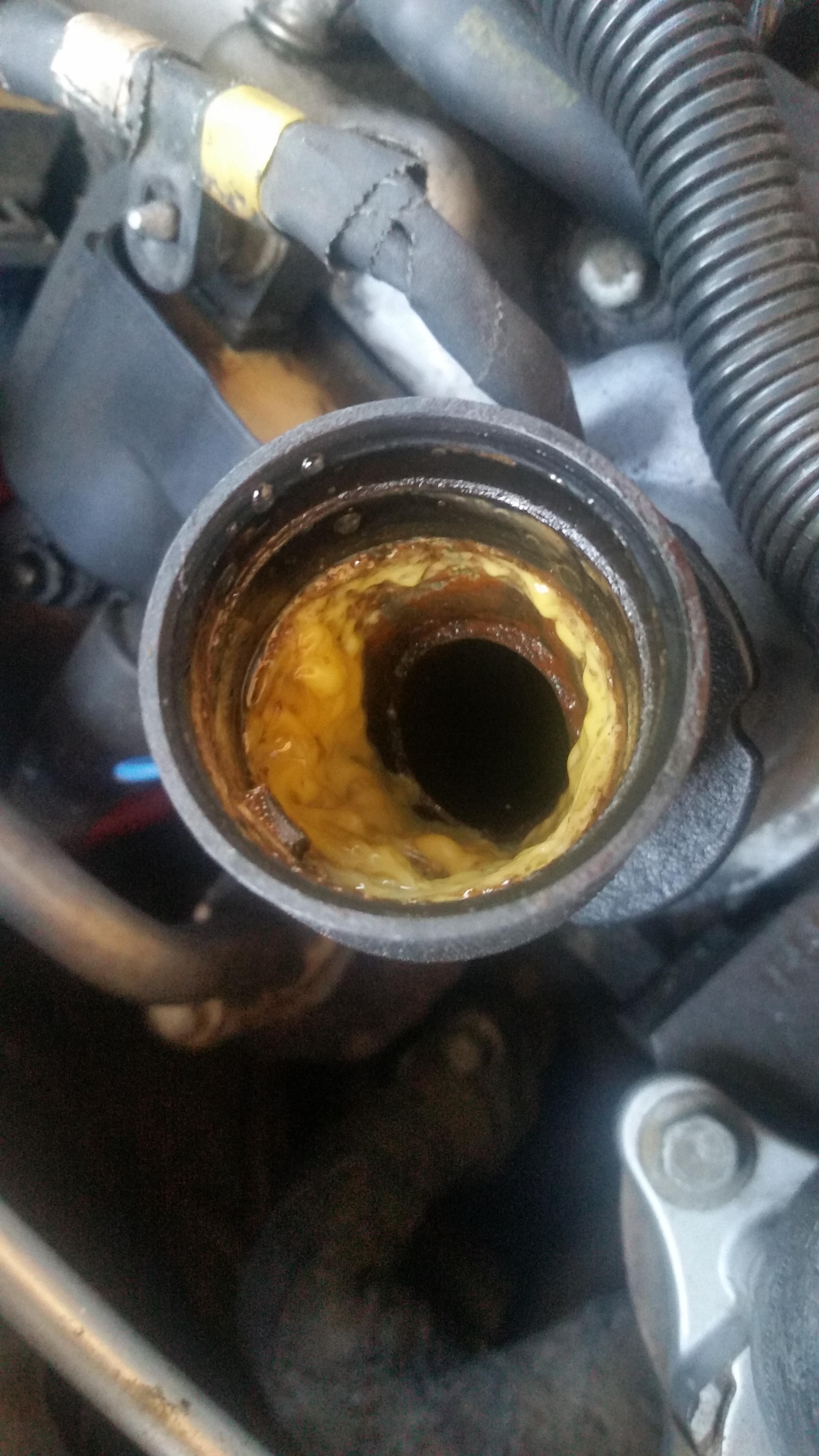 What is this gunk buildup around oil fill neck r/MechanicAdvice