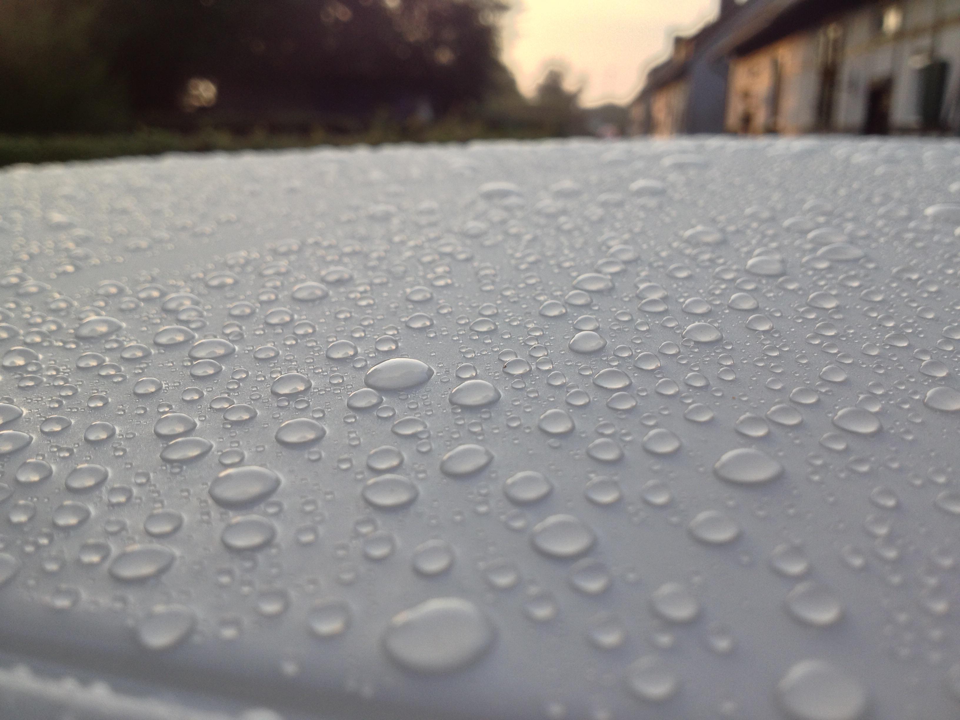 Water on my freshly waxed car roof at sunrise. Taken with iPhone 4s