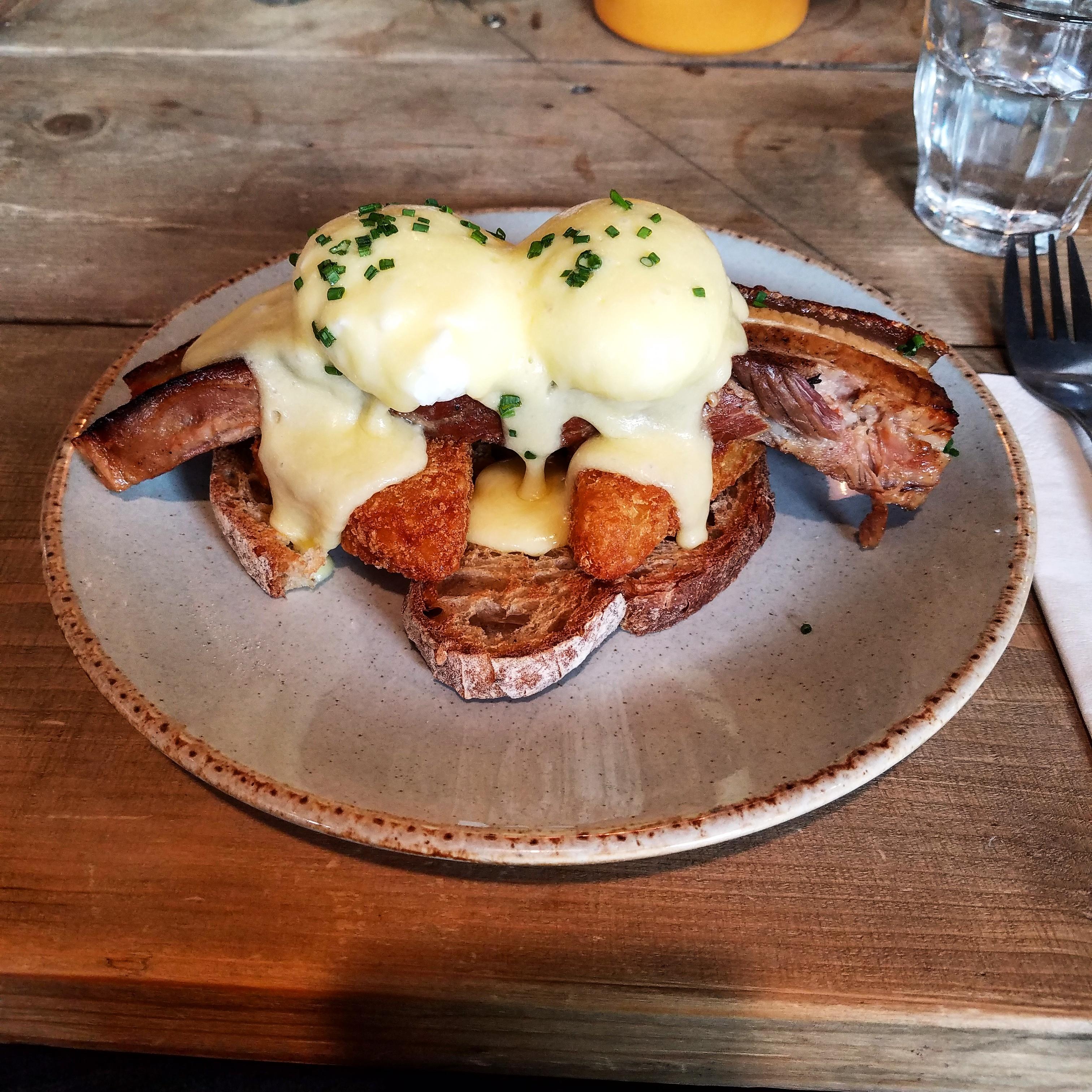 Slow cooked pork belly, hash browns, caramelized onions, and sourdough topped with poached eggs