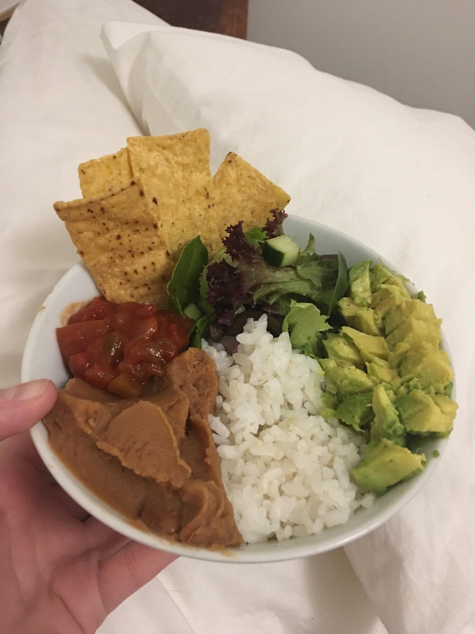 Burrito bowl with refried pinto beans, sticky rice, avocado, cucumber