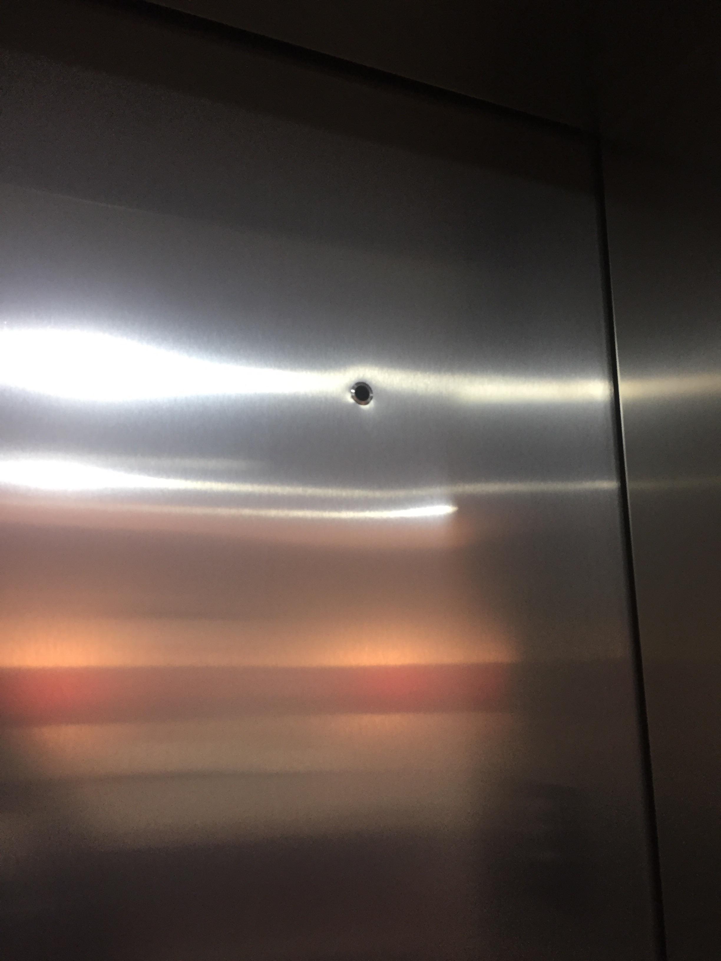 I keep seeing these holes on the top right of elevator doors. Why do