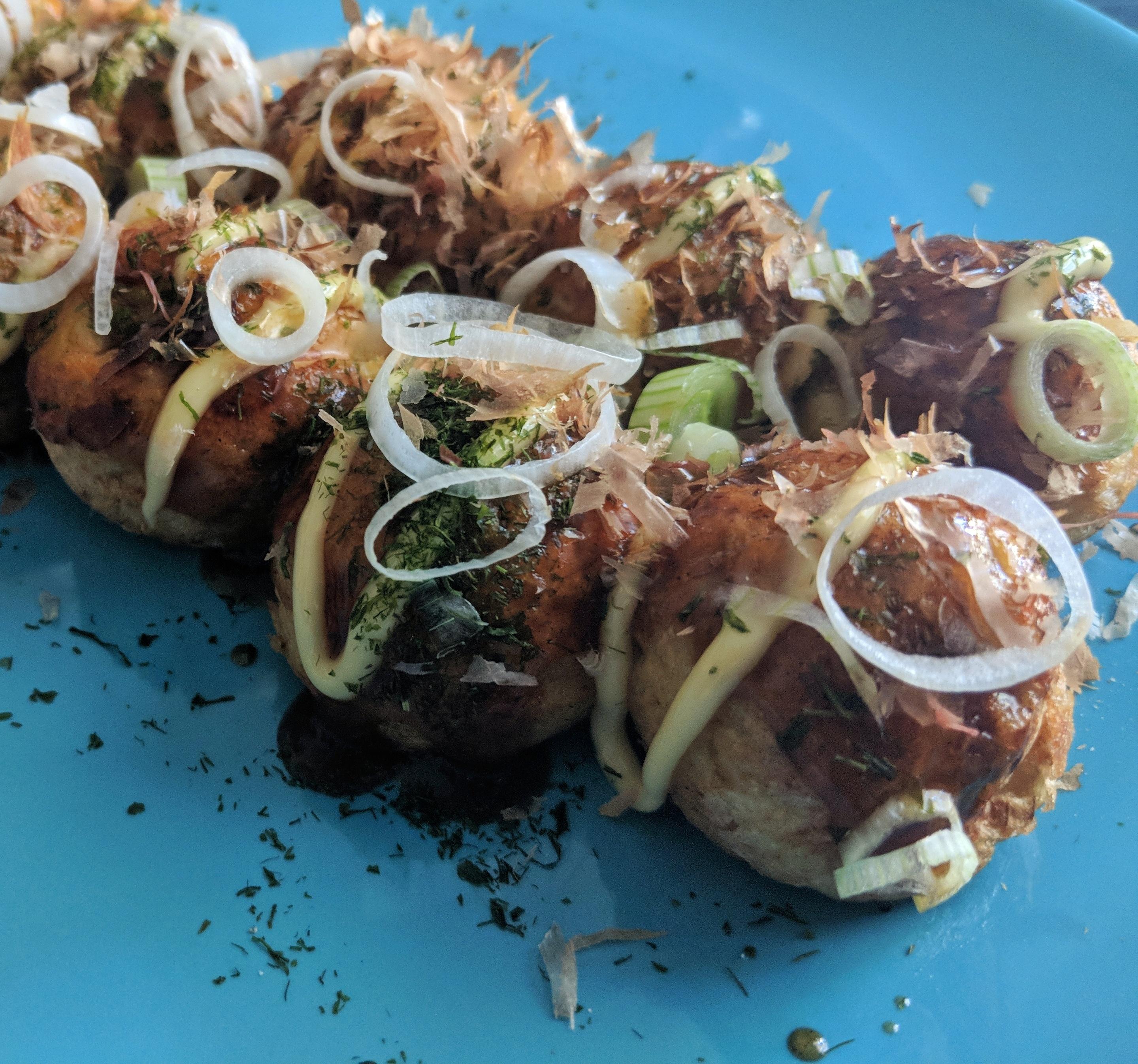 Homemade takoyaki topped with okonomiyaki sauce, Japanese mayo, aonori