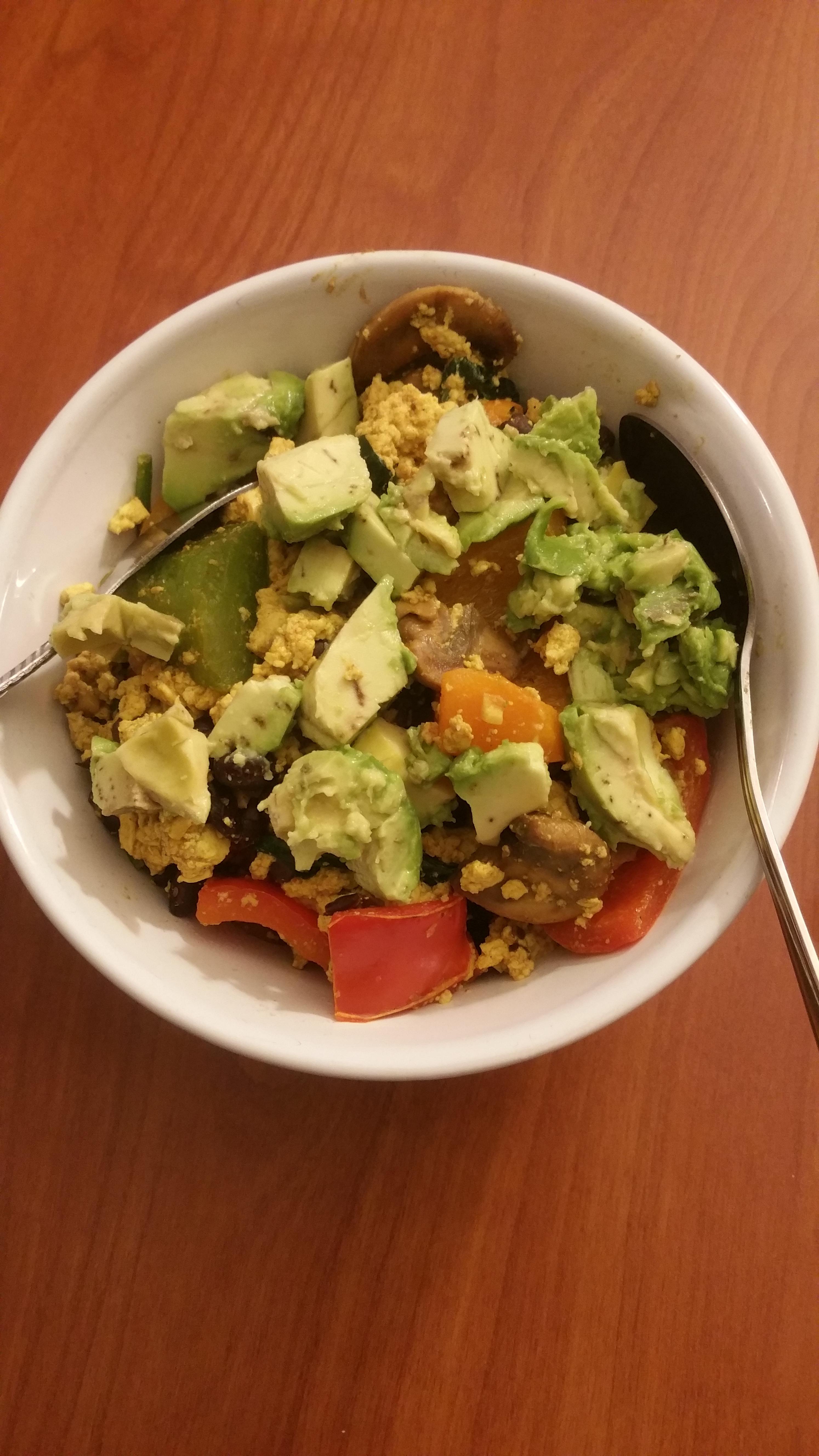 Tofu scramble with black beans, mushrooms and veggies, topped with