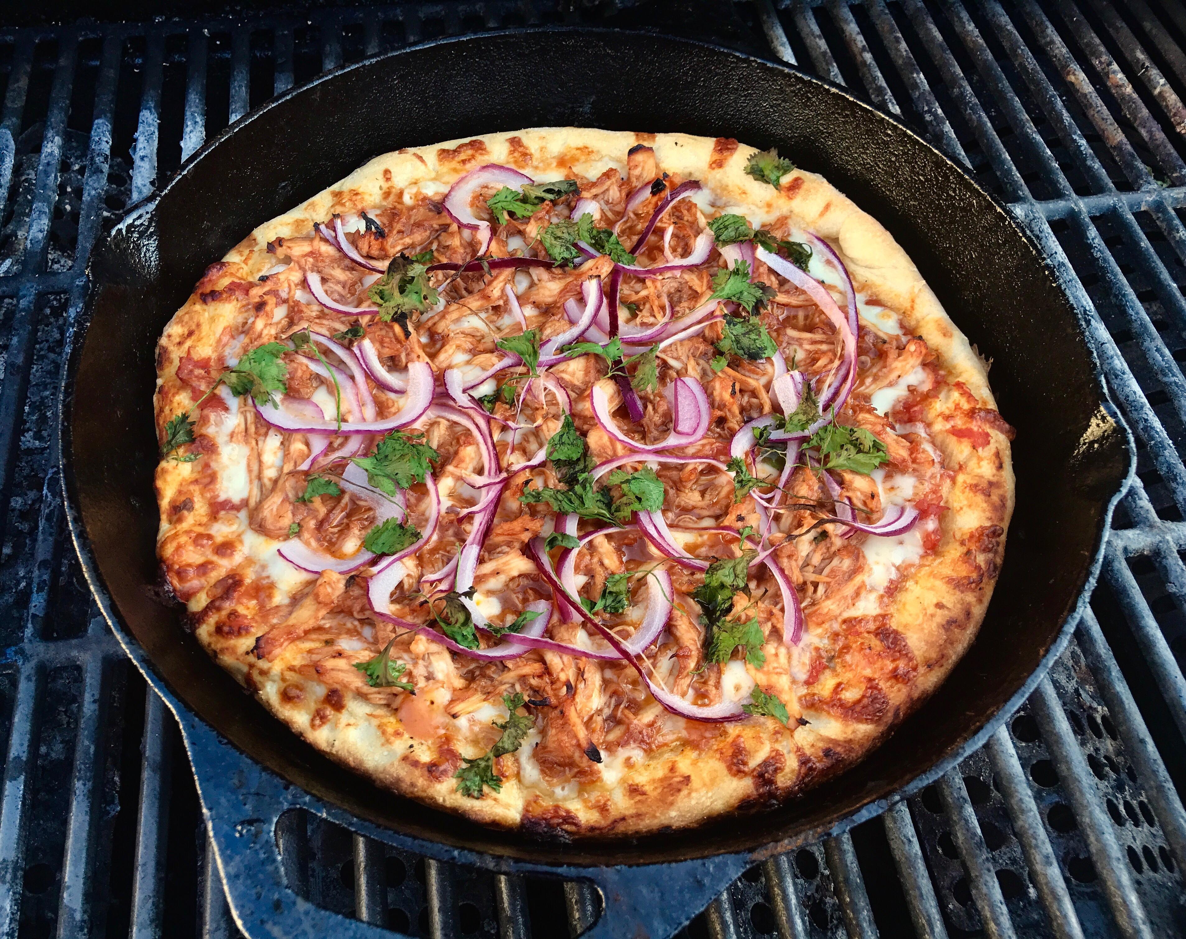 Decided to try making my first pizza. In a cast iron. On a grill. r/Pizza