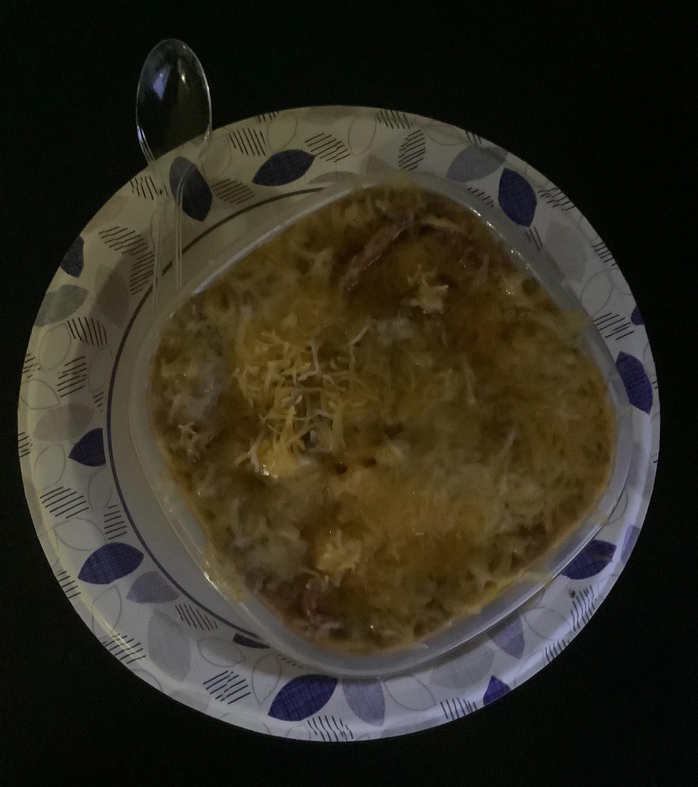 A square bowl of Refried Beans combined with Lard, Ground Beef, Bacon