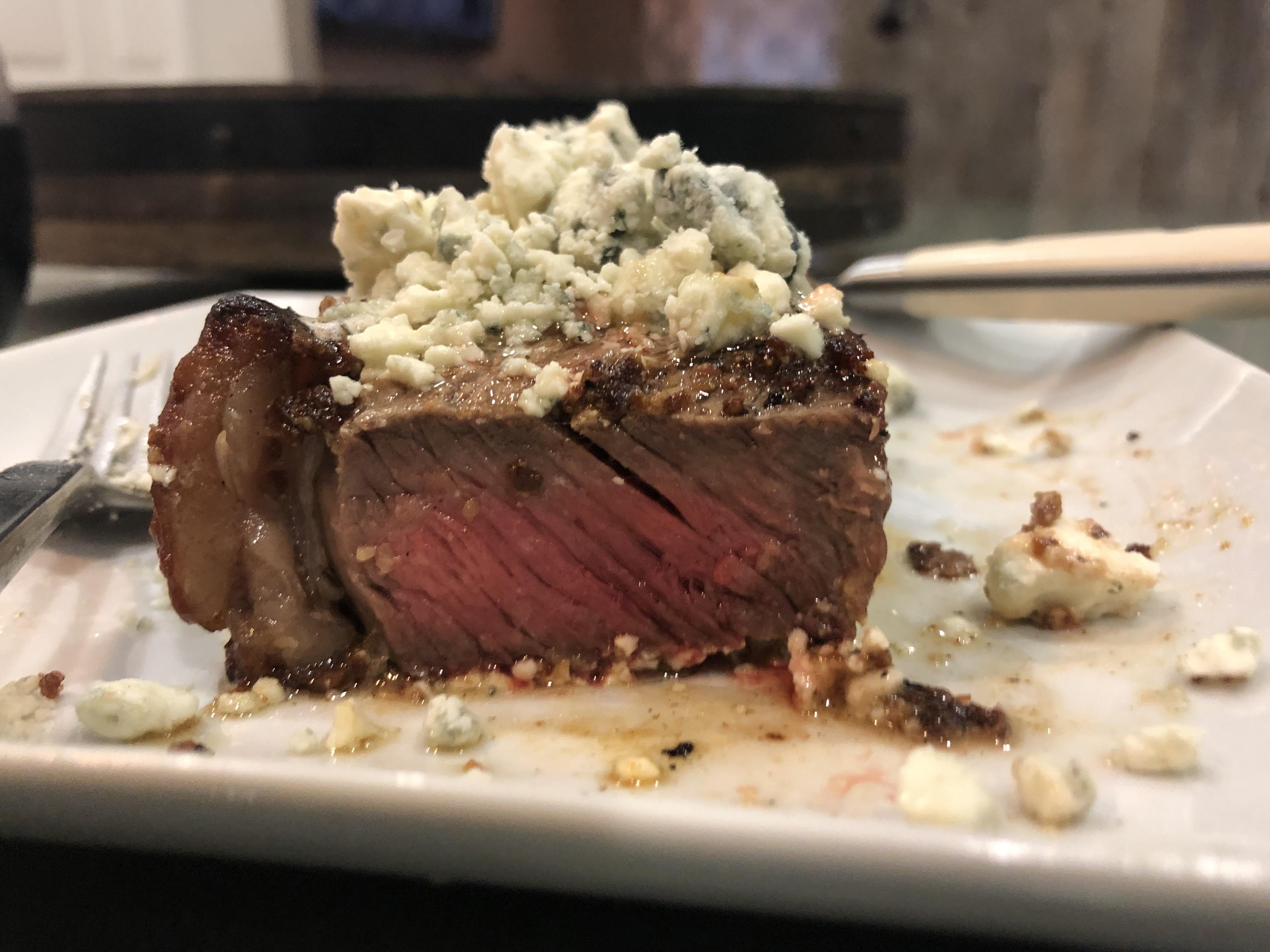 USDA Prime grade New York steak. Medium rare with blue cheese on top.👅