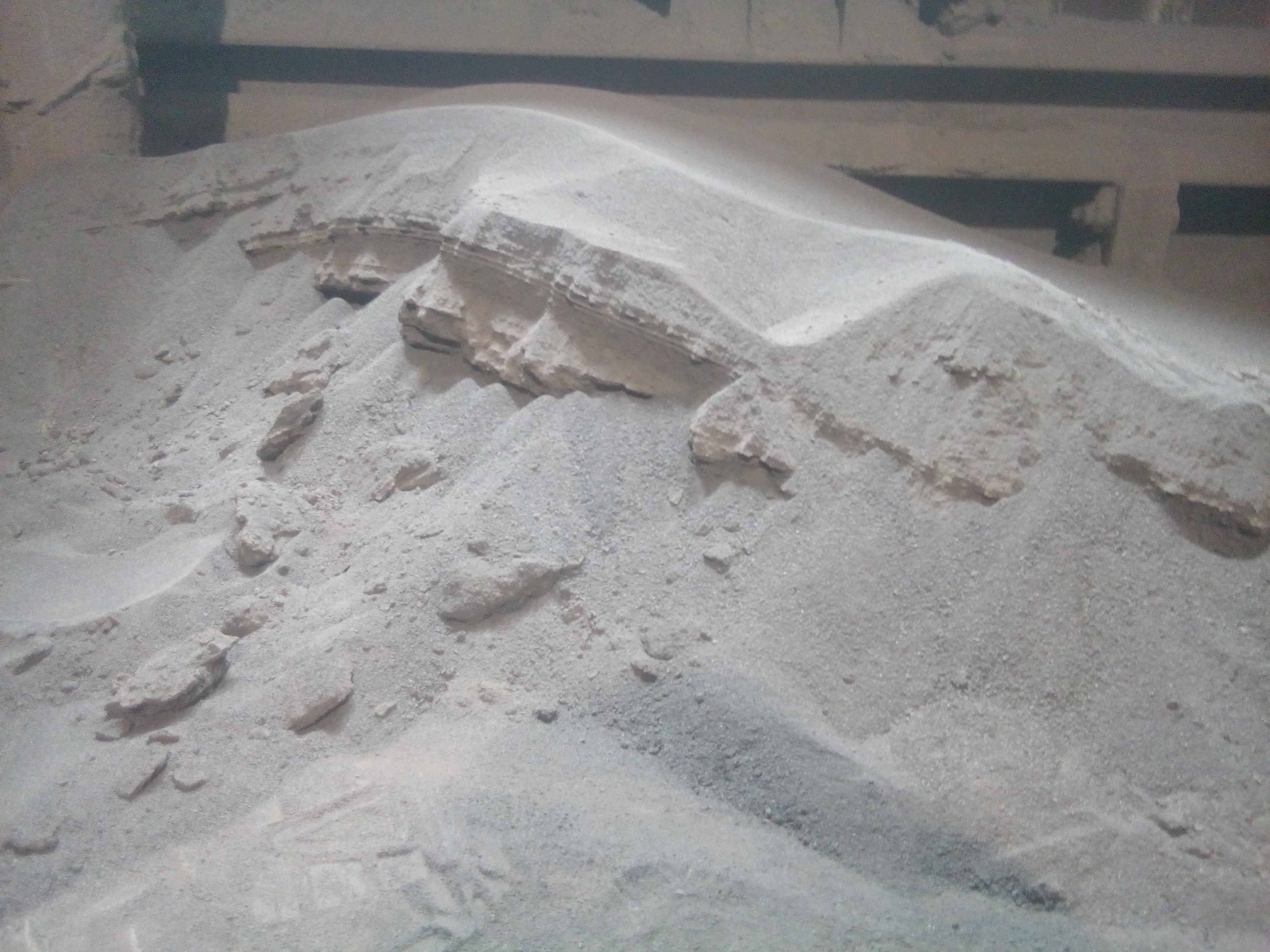 Sediment layers in a pile of dust at a quarry r/geology