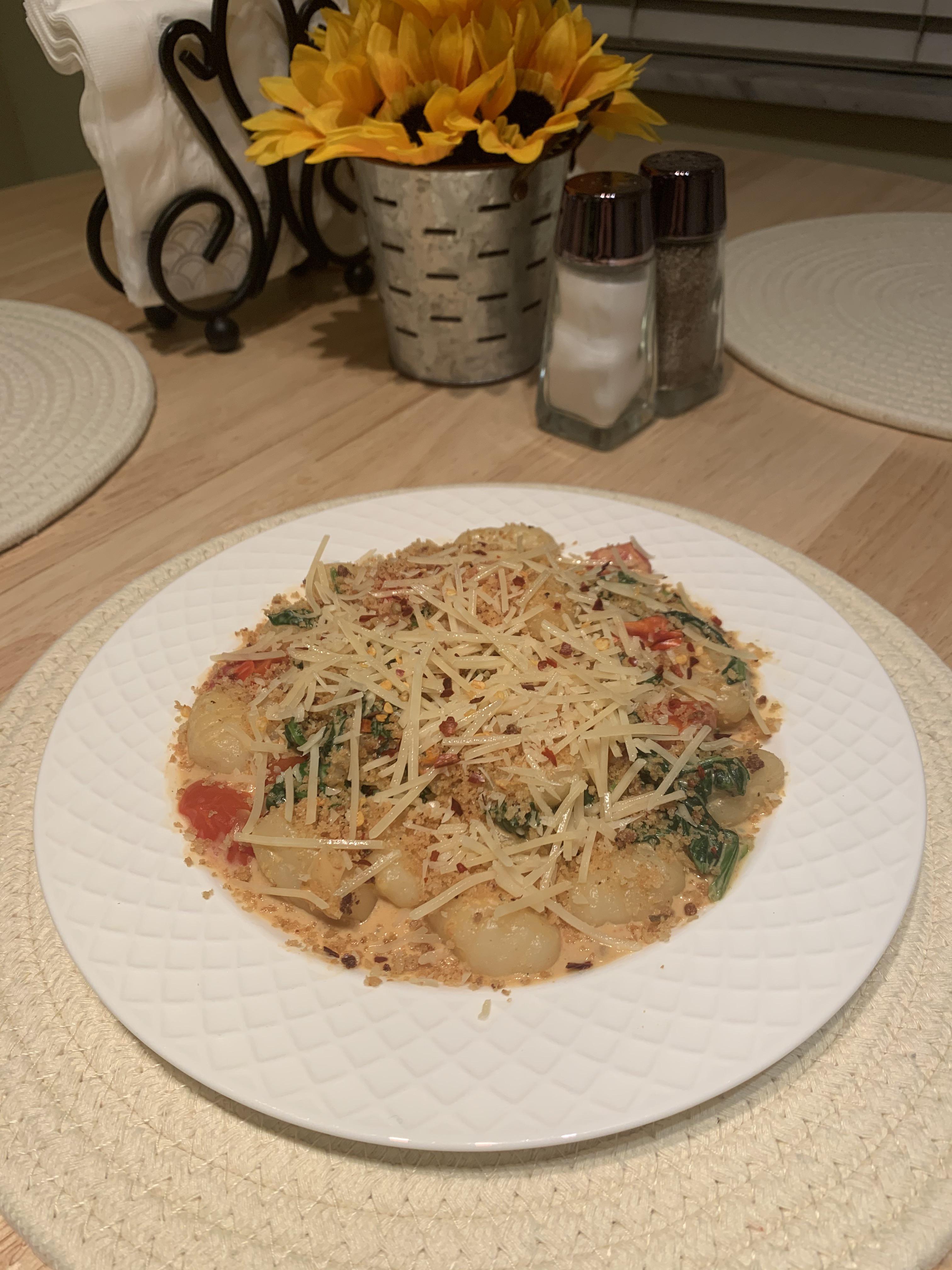 Gnocchi with spinach, grape tomatoes, garlic breadcrumbs, Parmesan, and