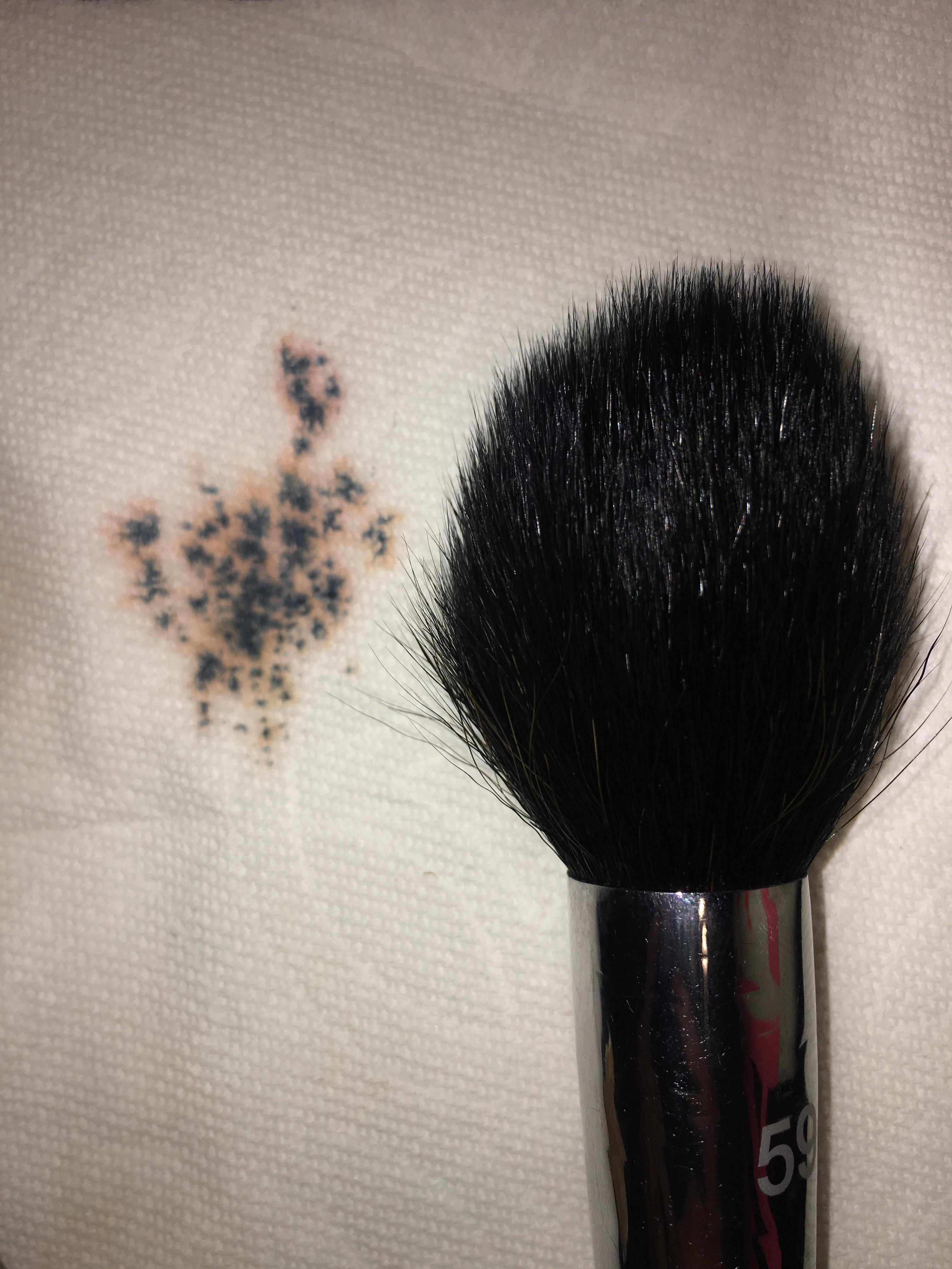 Black spot left behind on a paper towel after washing my natural hair