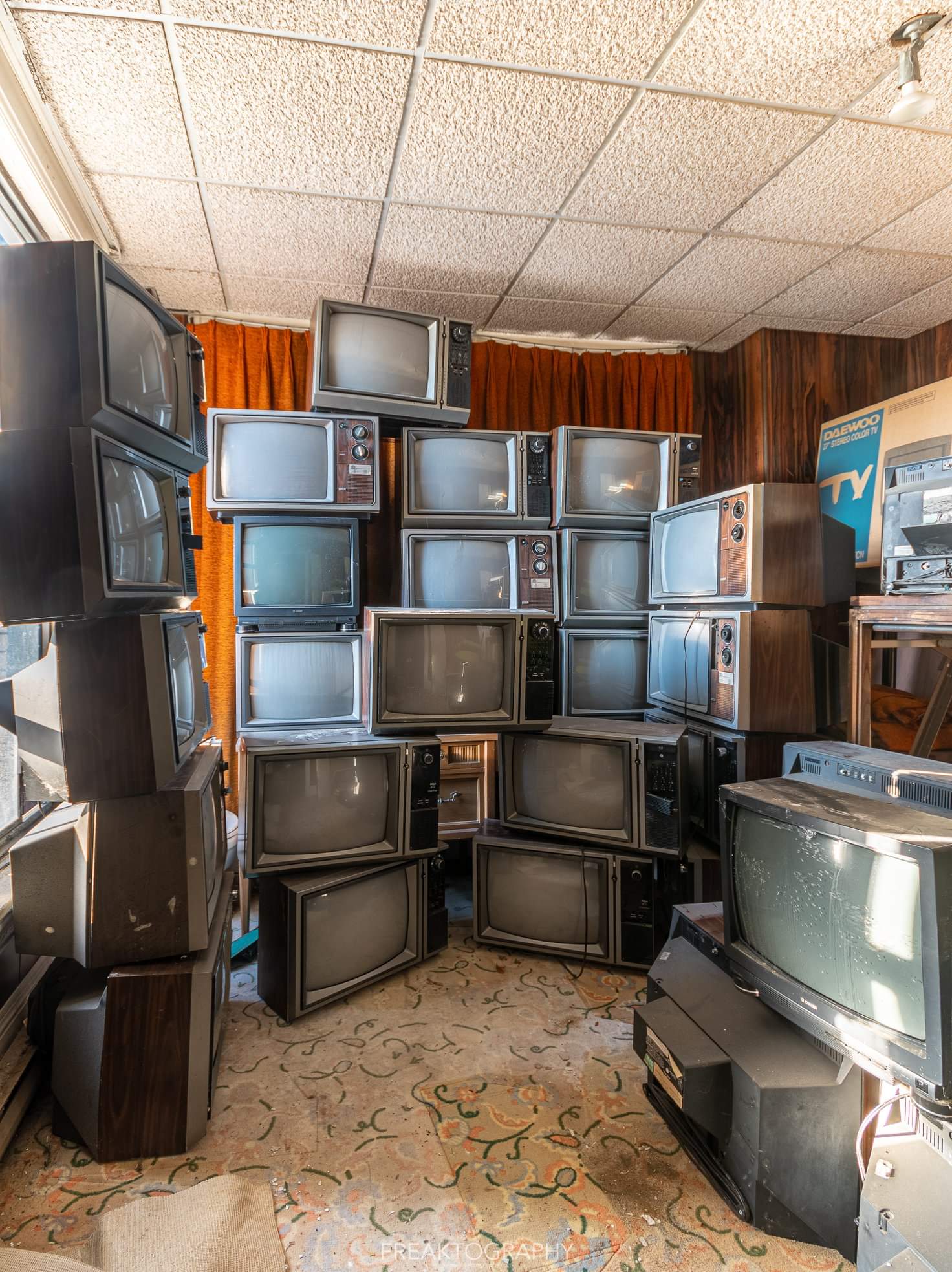 Stacked televisions in an old abandoned hotel stuck in the 1980s (oc