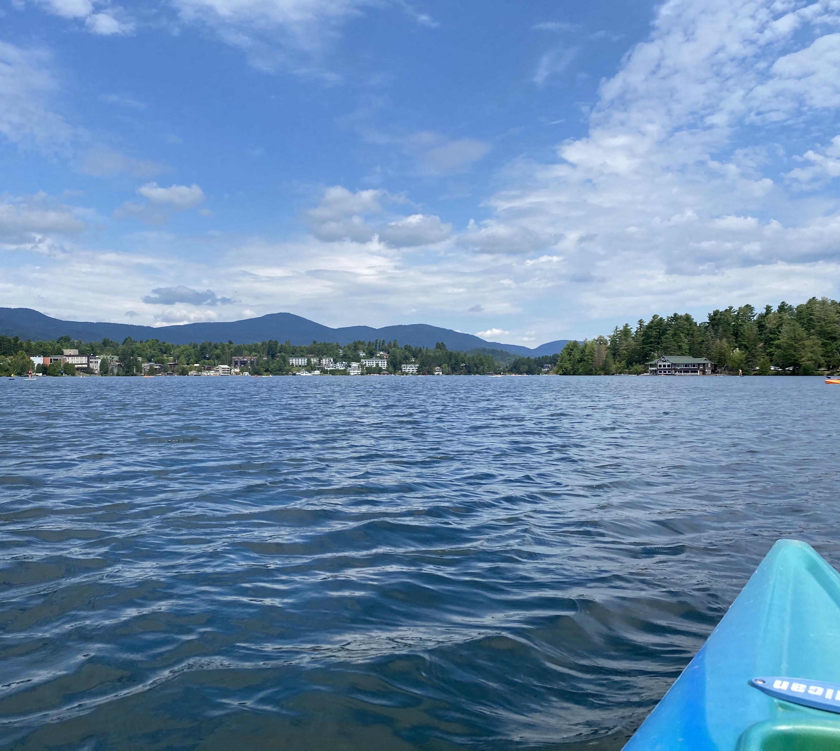 Kayaking in Mirror Lake with a view of the Adirondack Mountains, in