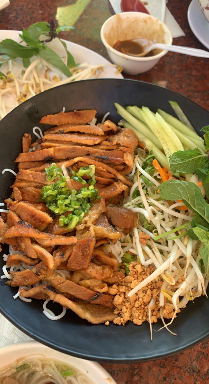 delicious pork vermicelli dish with beansprouts, cucumbers, pickled carrots, green onions r
