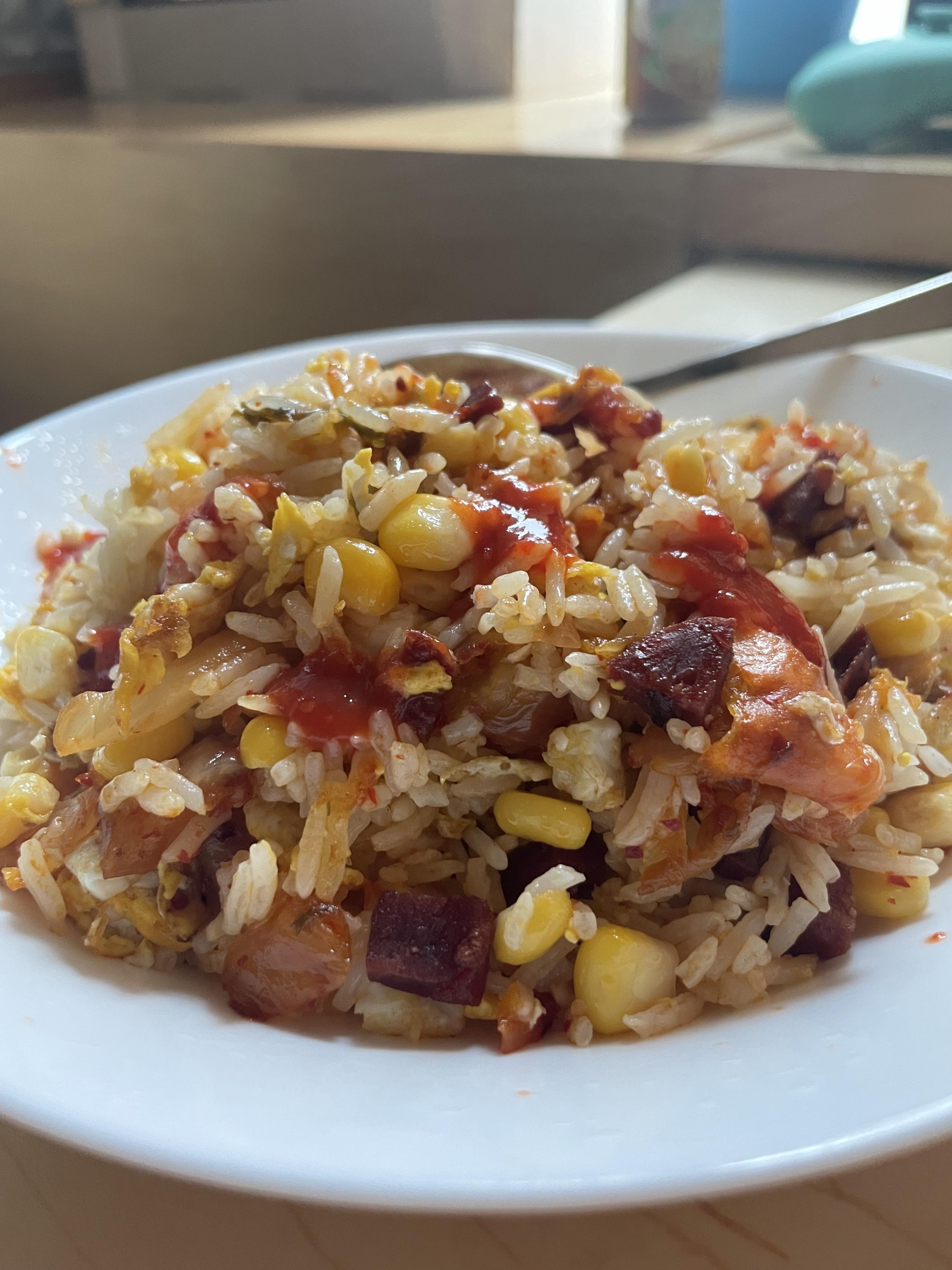 Chorizo, kimchi, egg, and corn fried rice with Yellowbird sriracha r