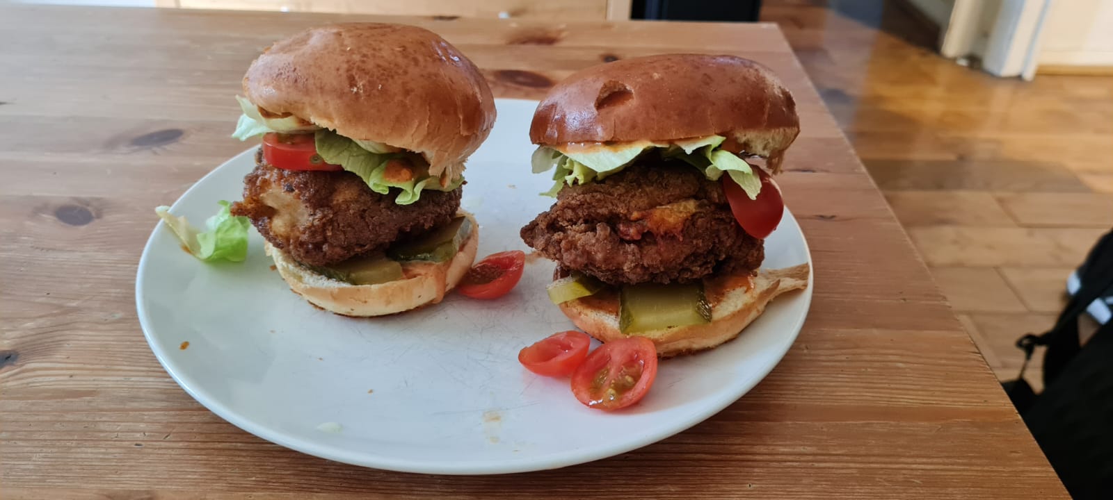 Home made deep fried chicken burgers on brioche buns with hotsauce and