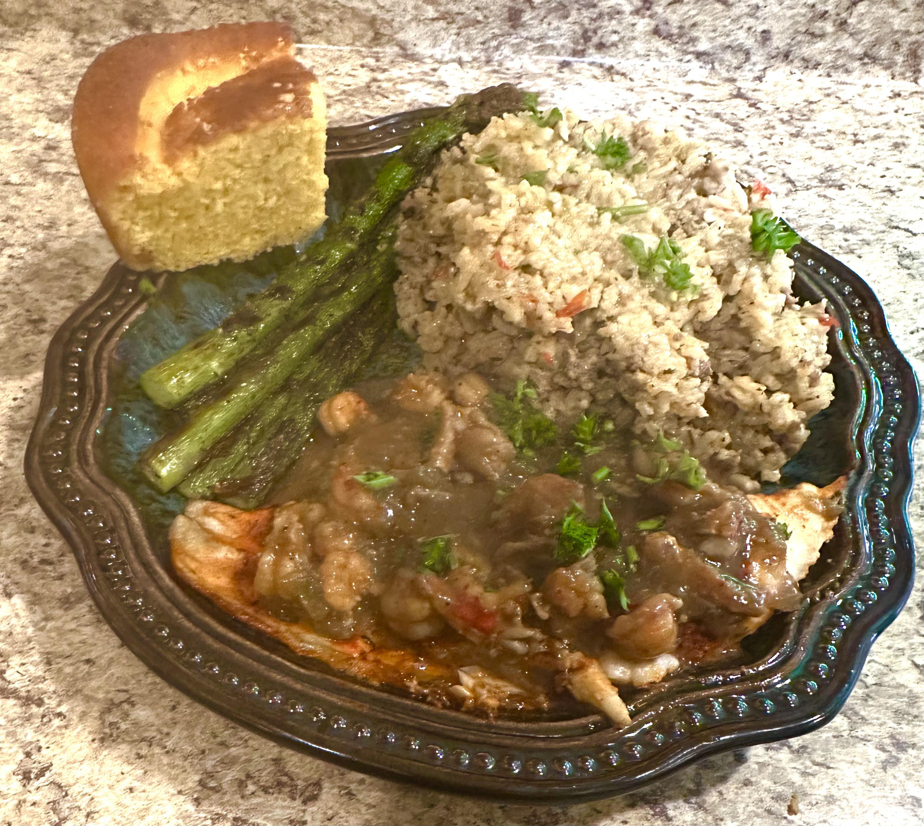 Catfish topped with Crawfish Étouffée, Dirty Rice, Asparagus, and