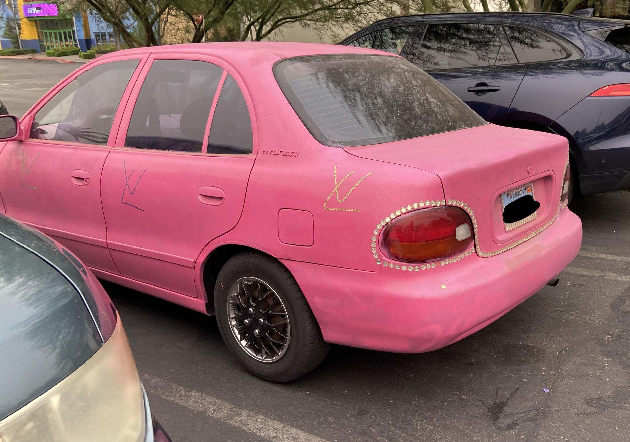 Uneven paint job, gaudy color, bedazzled, and fake branding. Check