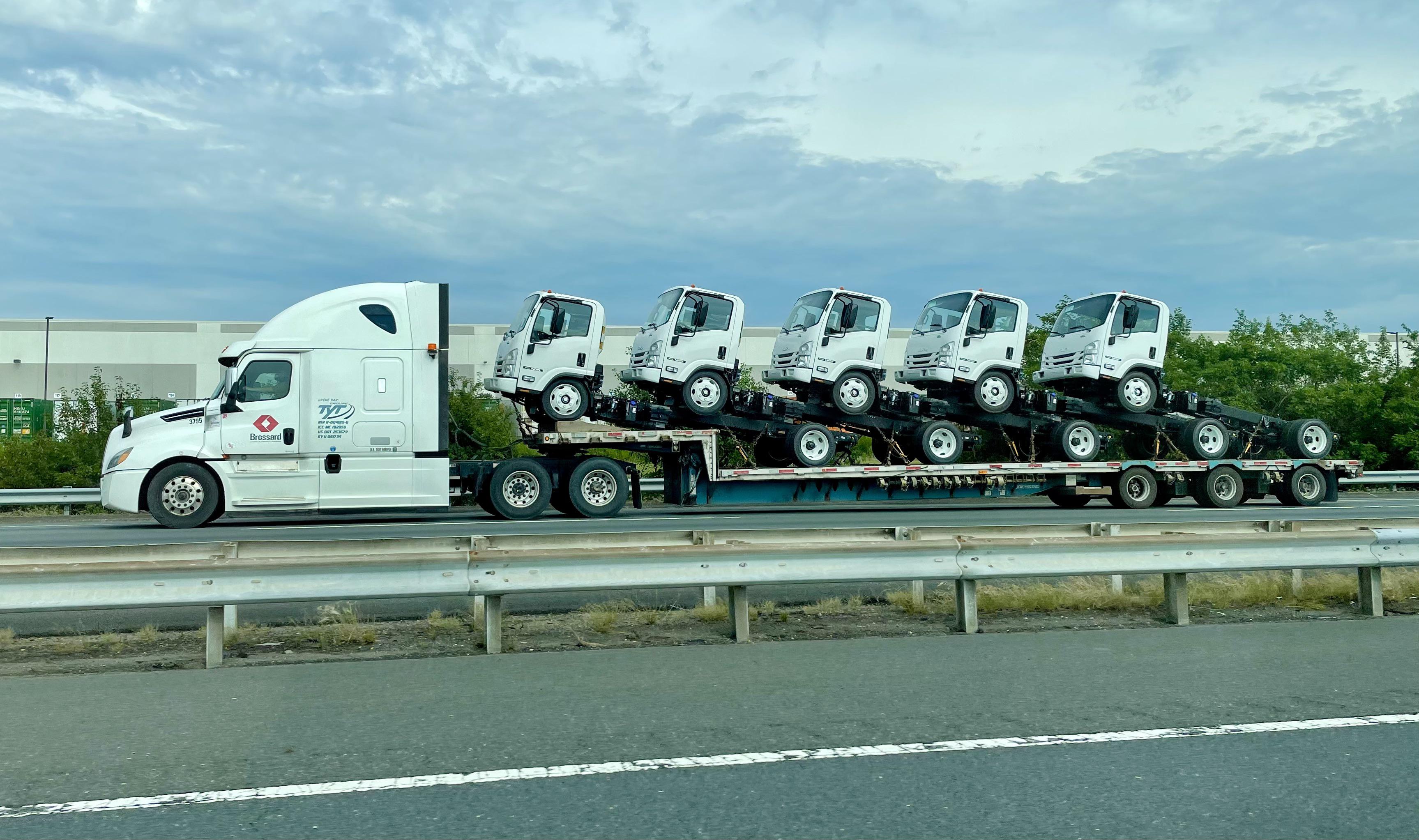 A truck hauling 5 smaller trucks. r/mildlyinteresting