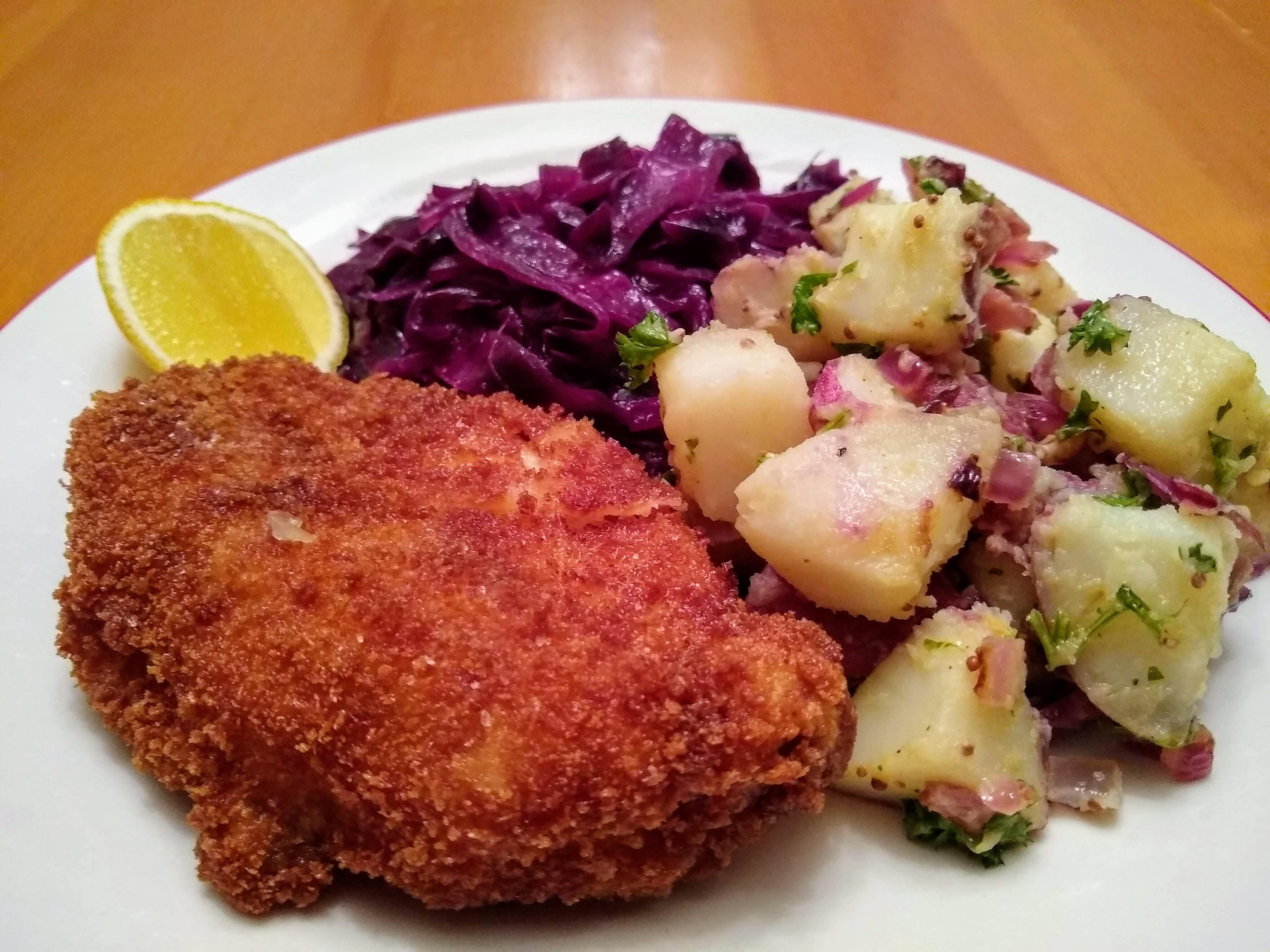 Pork schnitzel, potato salad, and red cabbage on a cold, rainy night