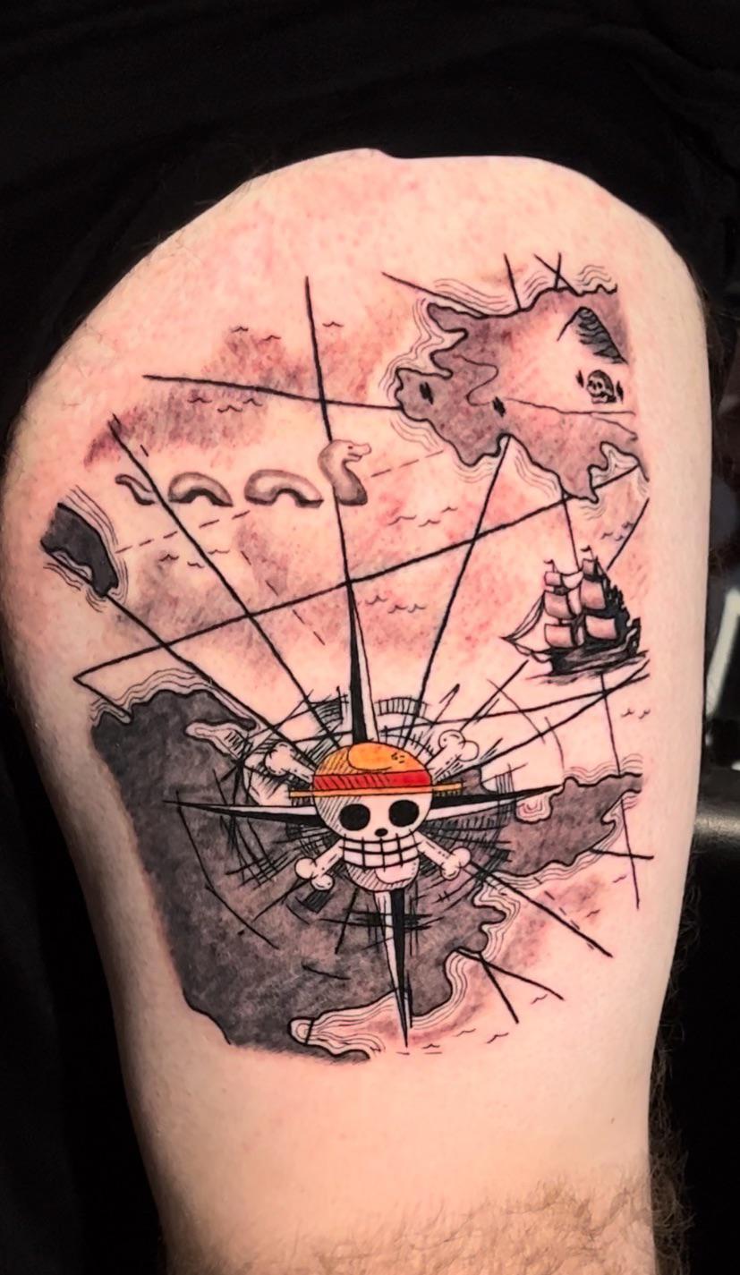 One piece logo and nautical map tattoo by Weng at First Class Tattoo