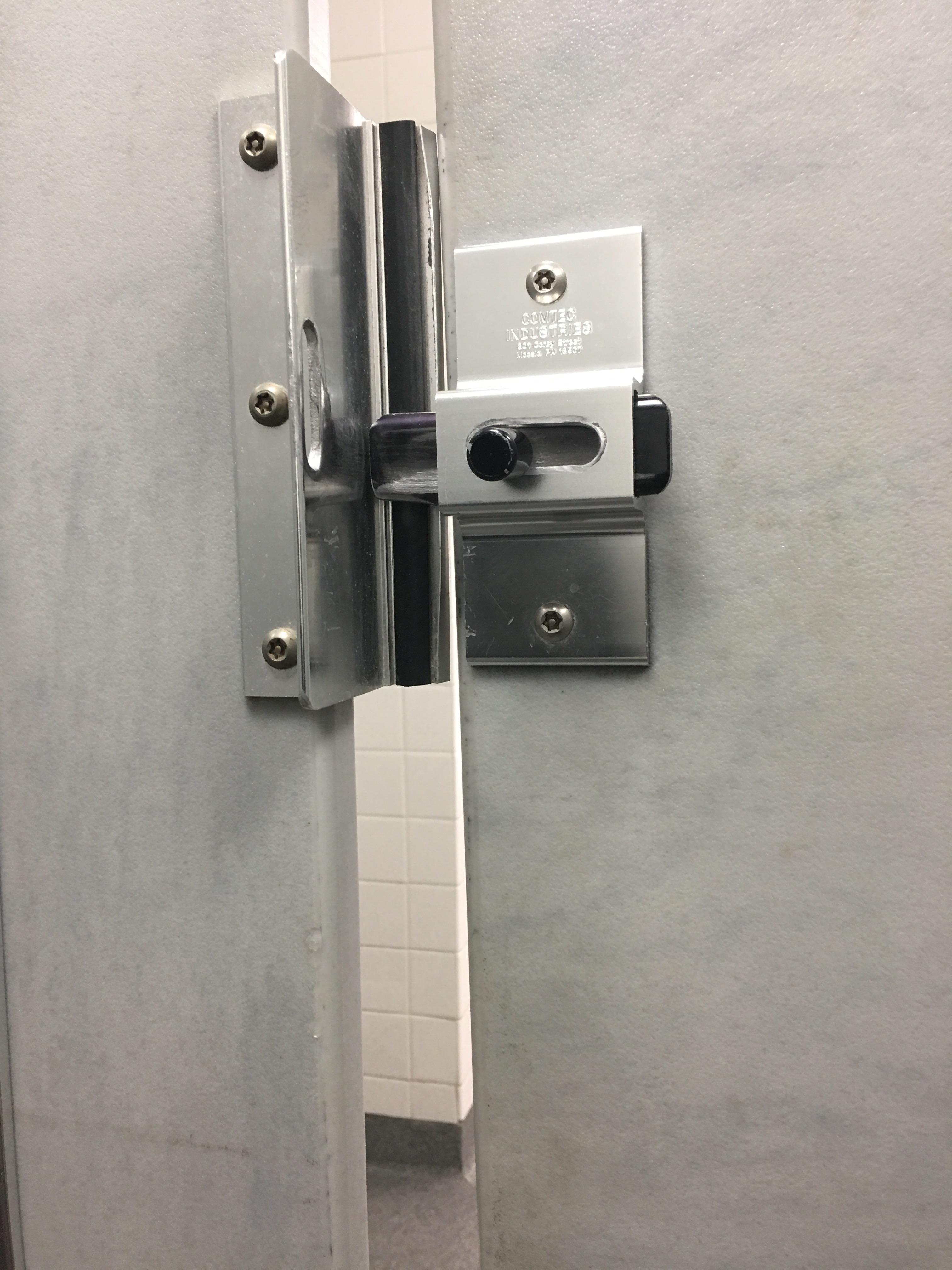 The bathroom stall door doesn't line up with the rest and won't close