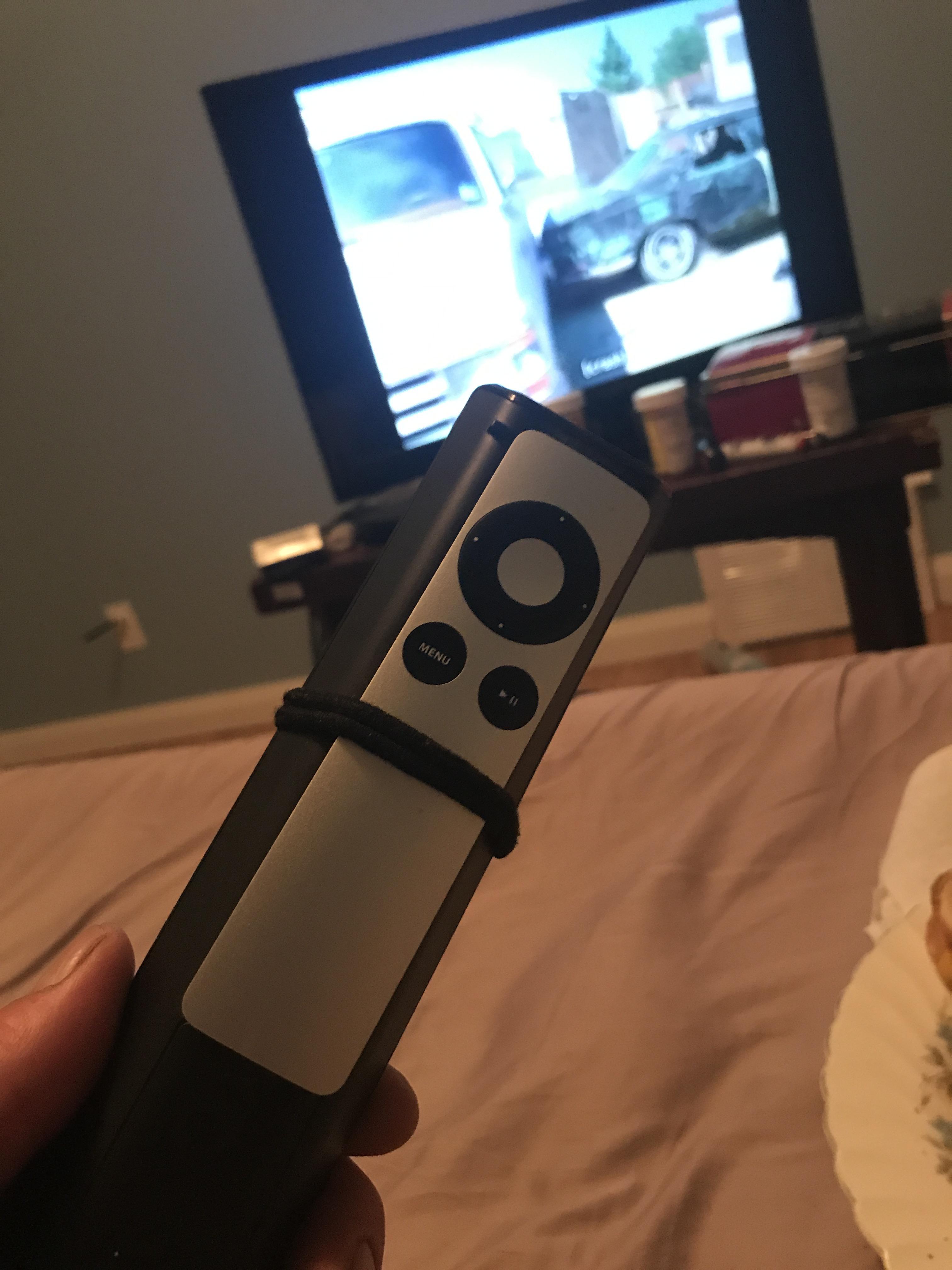 Using my wife’s hair ties to secure the old AppleTV remote to the tv