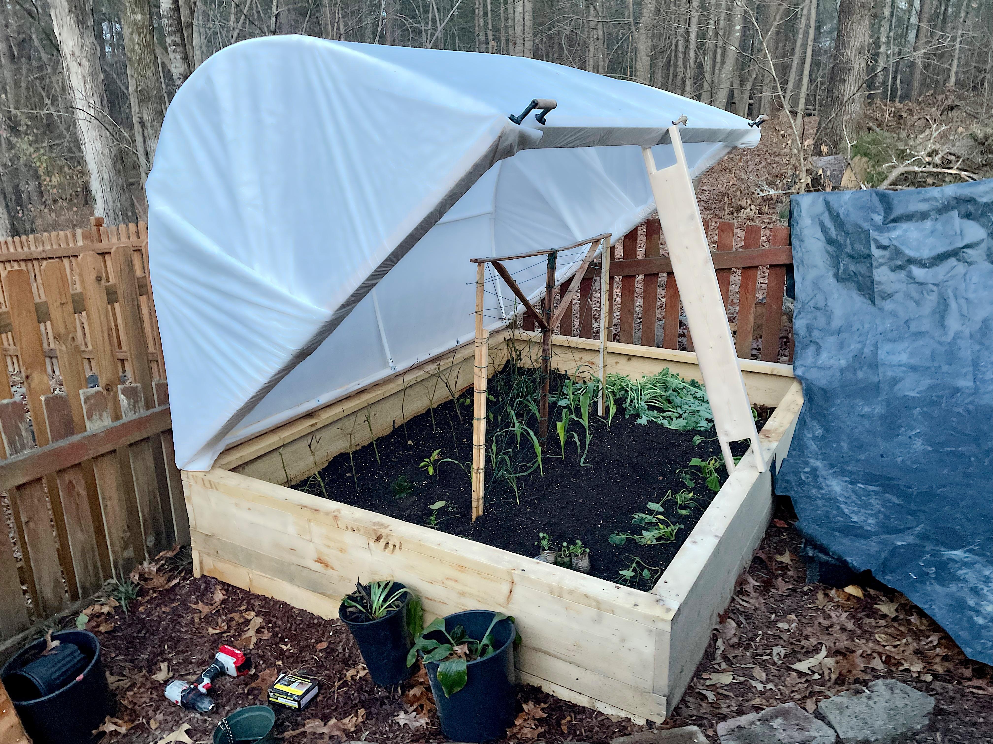 My first Hugelkultur raised bed hinged hoophouse. Just in time for winter. r/gardening
