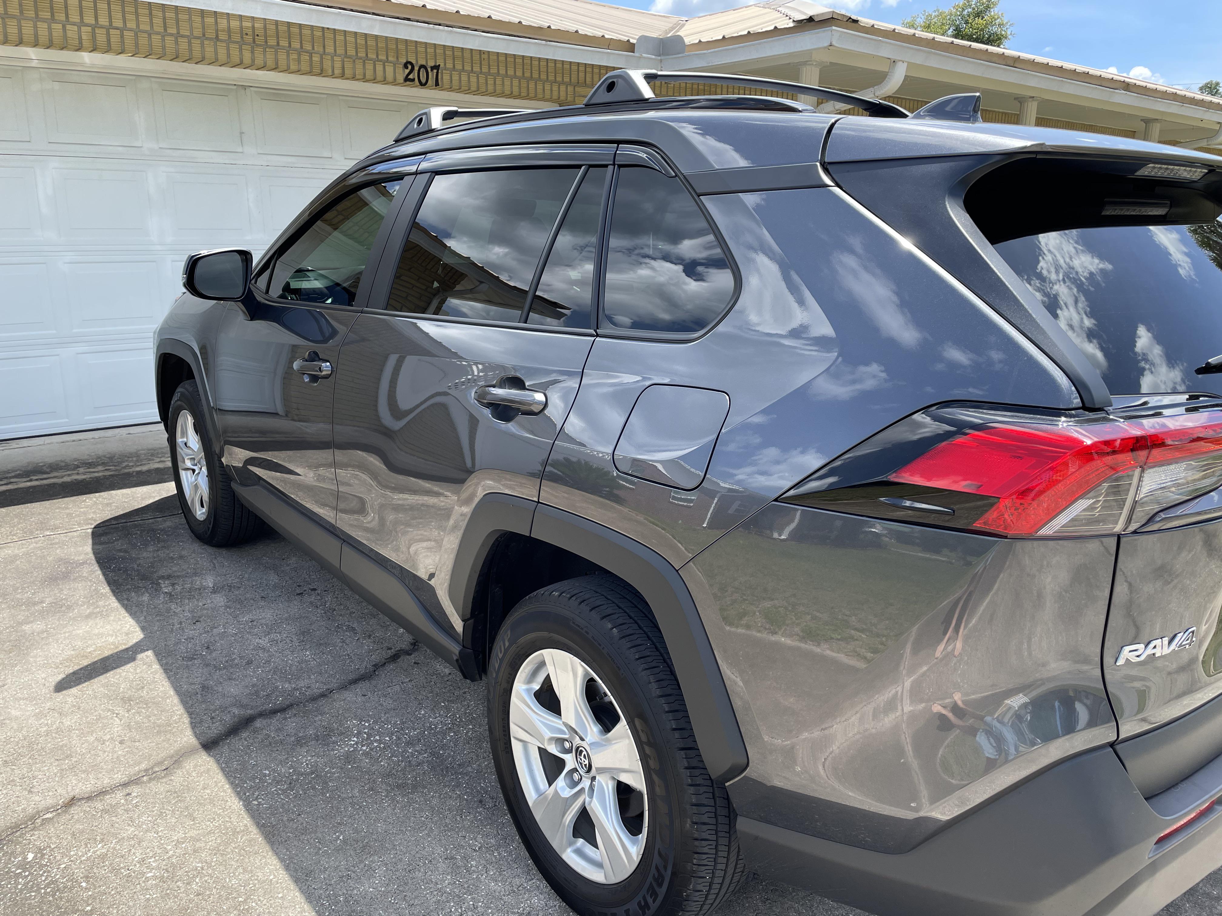 Windows tinted, roof rails installed, and rain guards that cover chrome
