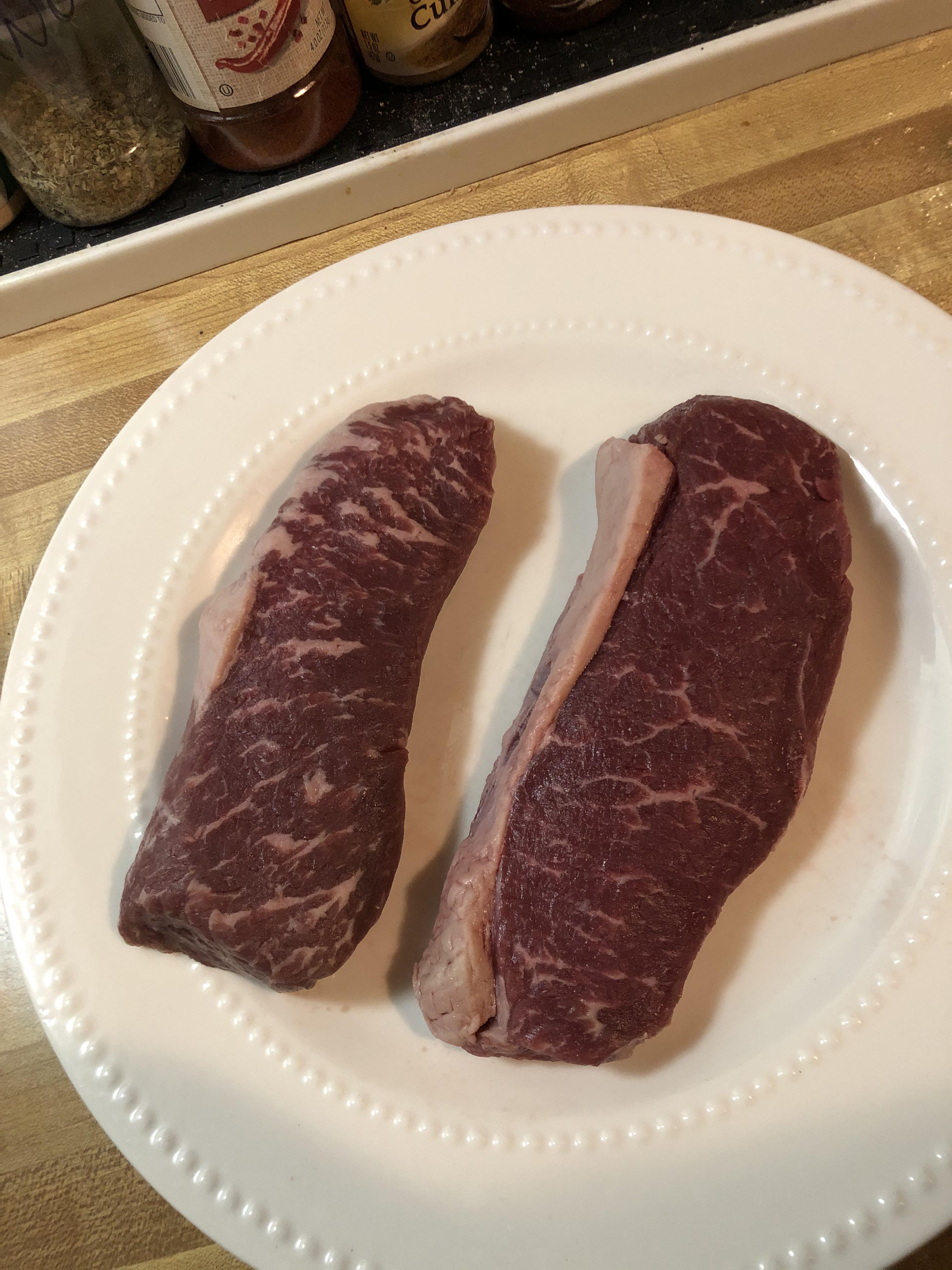 Check out the marbling and fat caps on these bad boys. r/steak