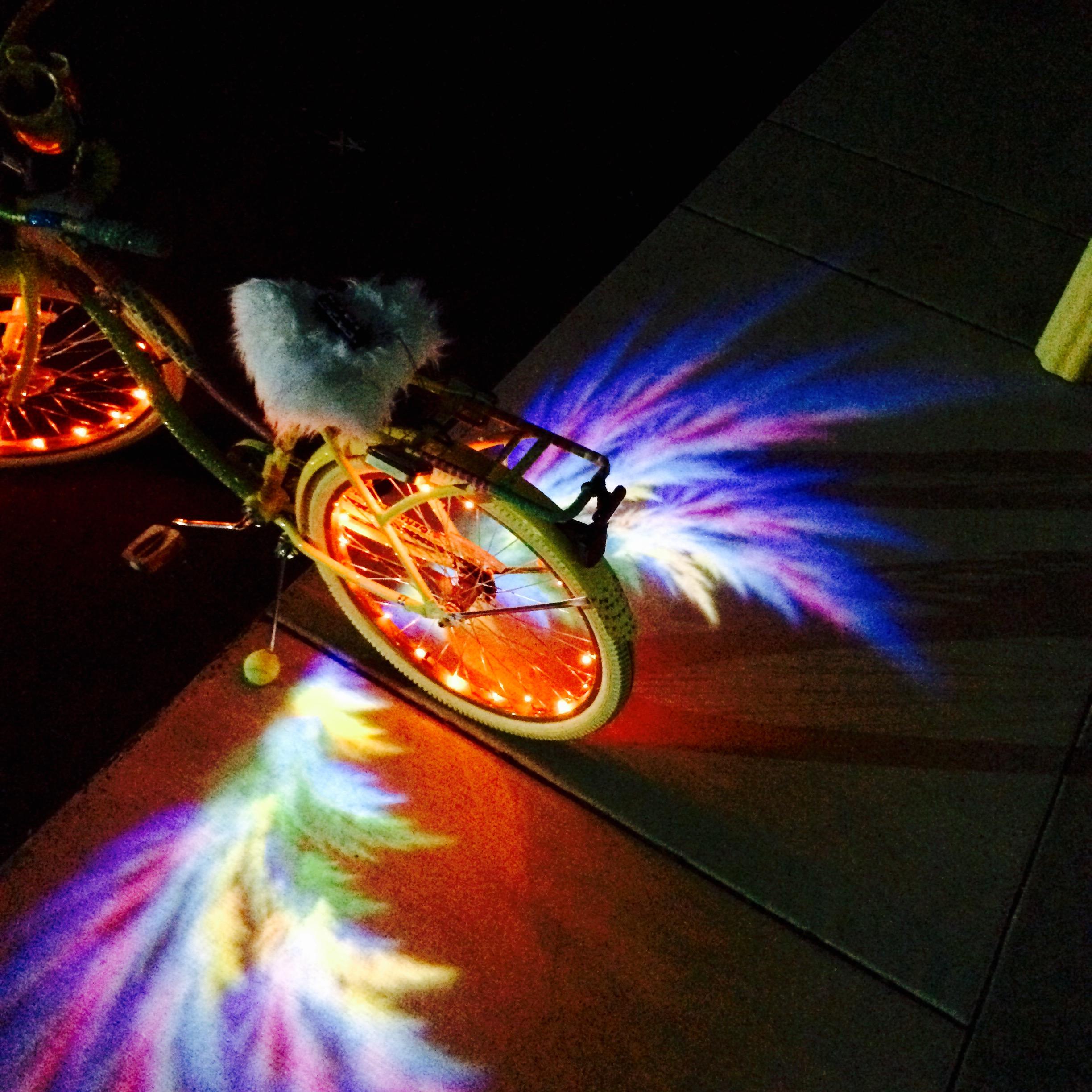 Playa bike projecting rainbow fractal angel wings on the ground r