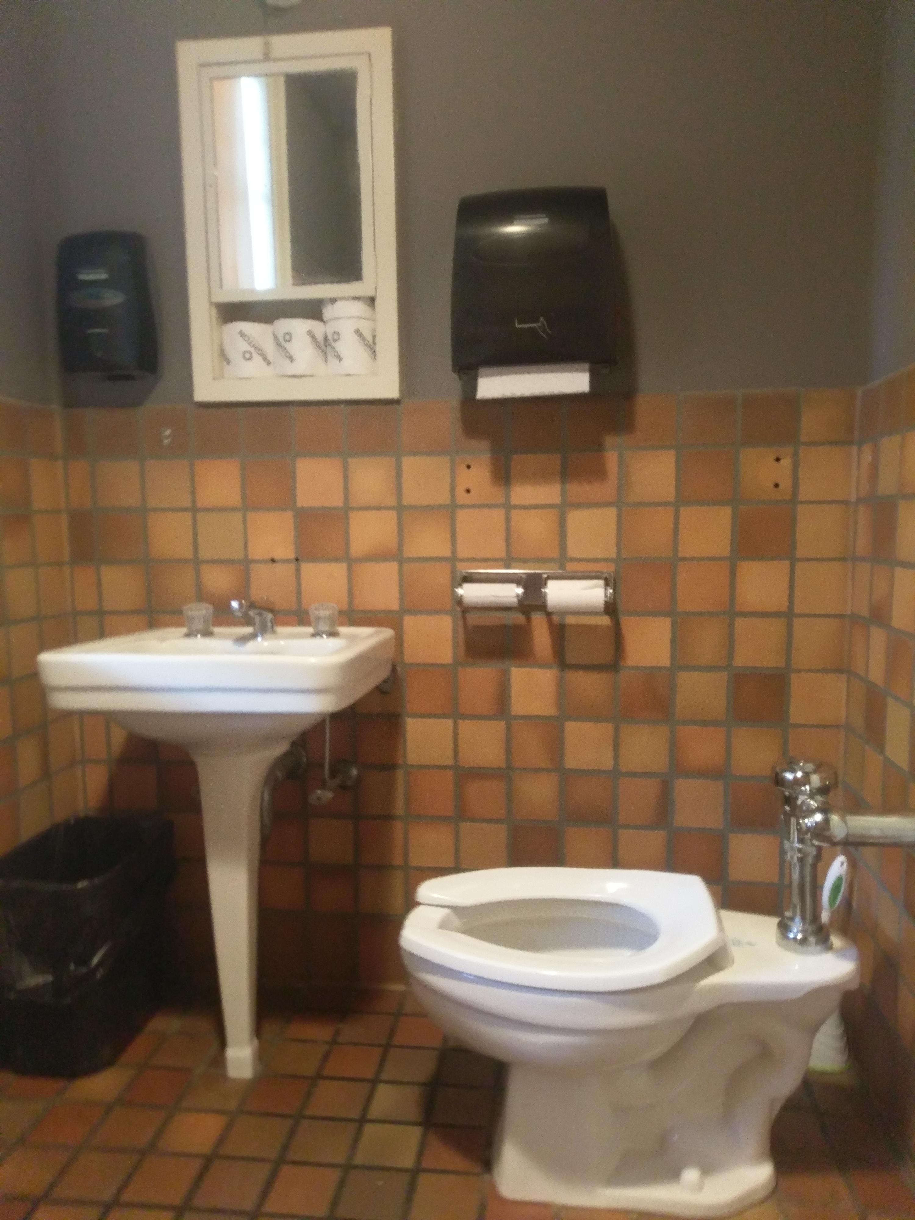 This toilet is facing the sink so when you pee the sink is right in