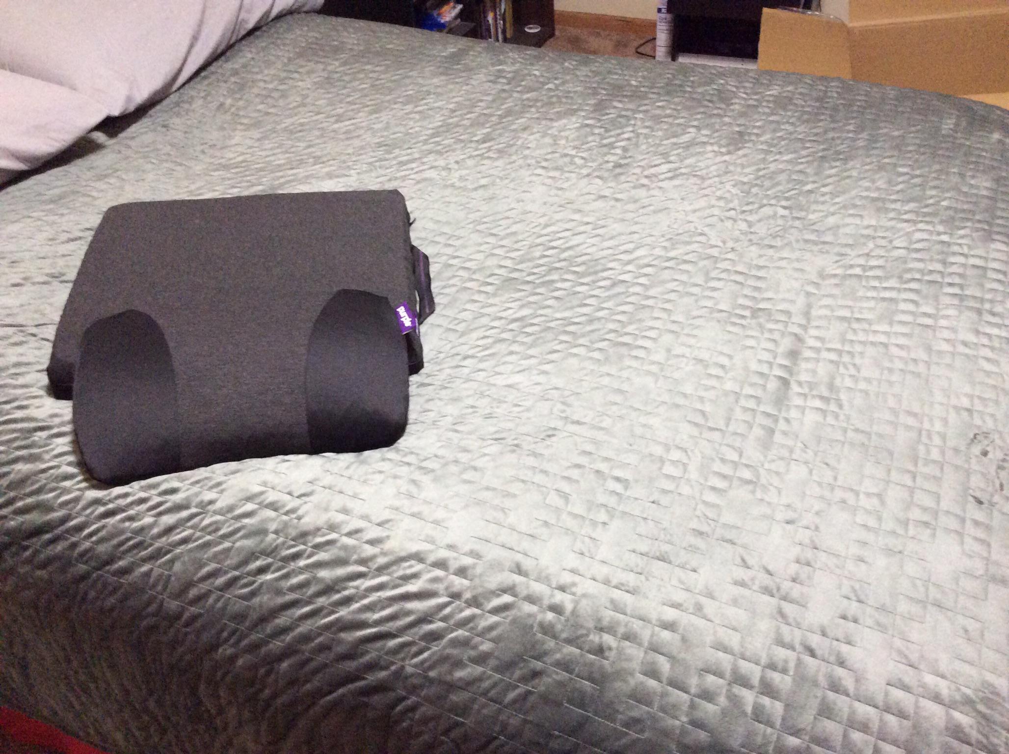 Purple Gravity Blanket placed on the bed, with a cameo of my seat
