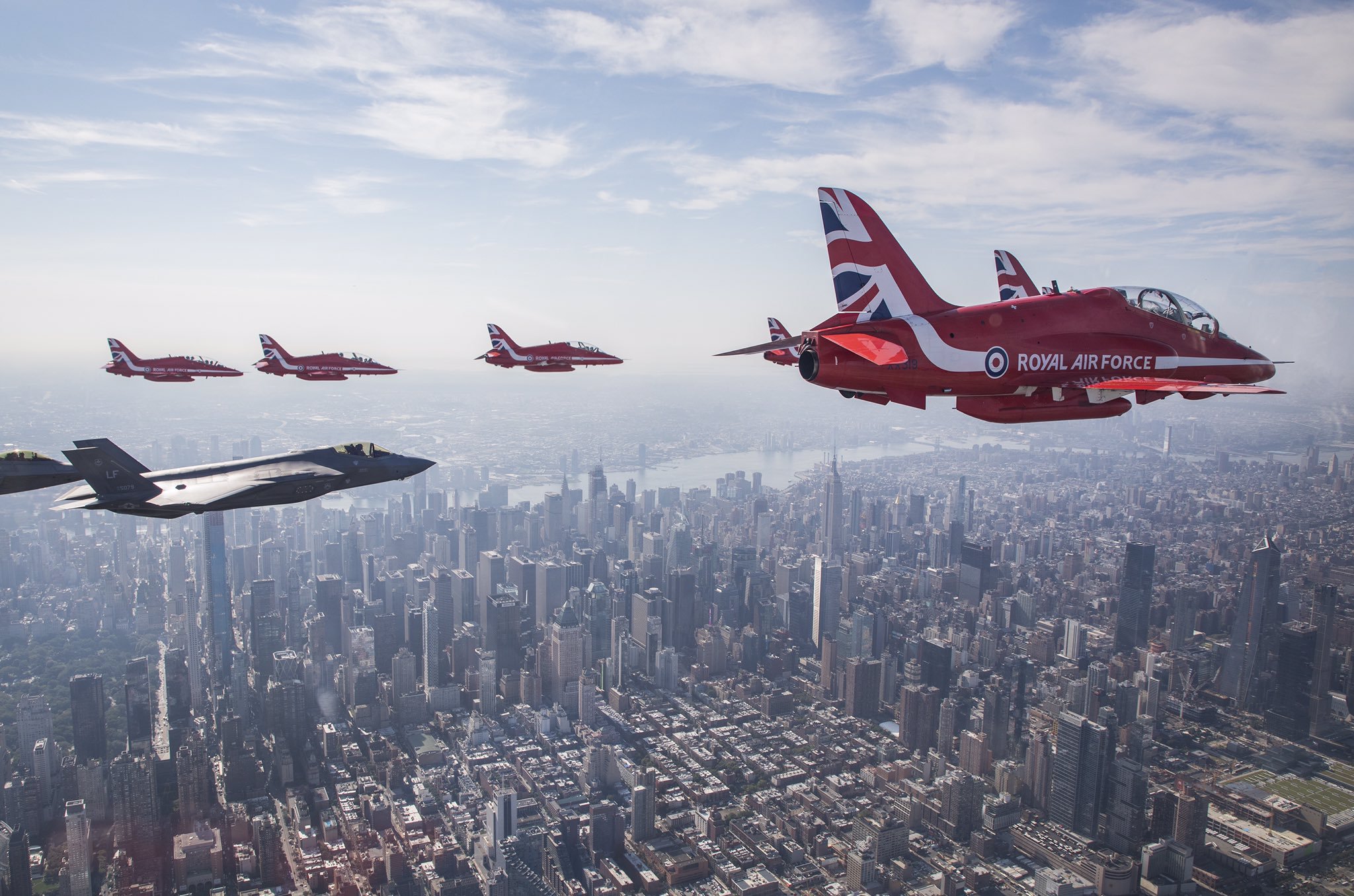 The Royal Air Force Red Arrows and a F35 flying over New York City