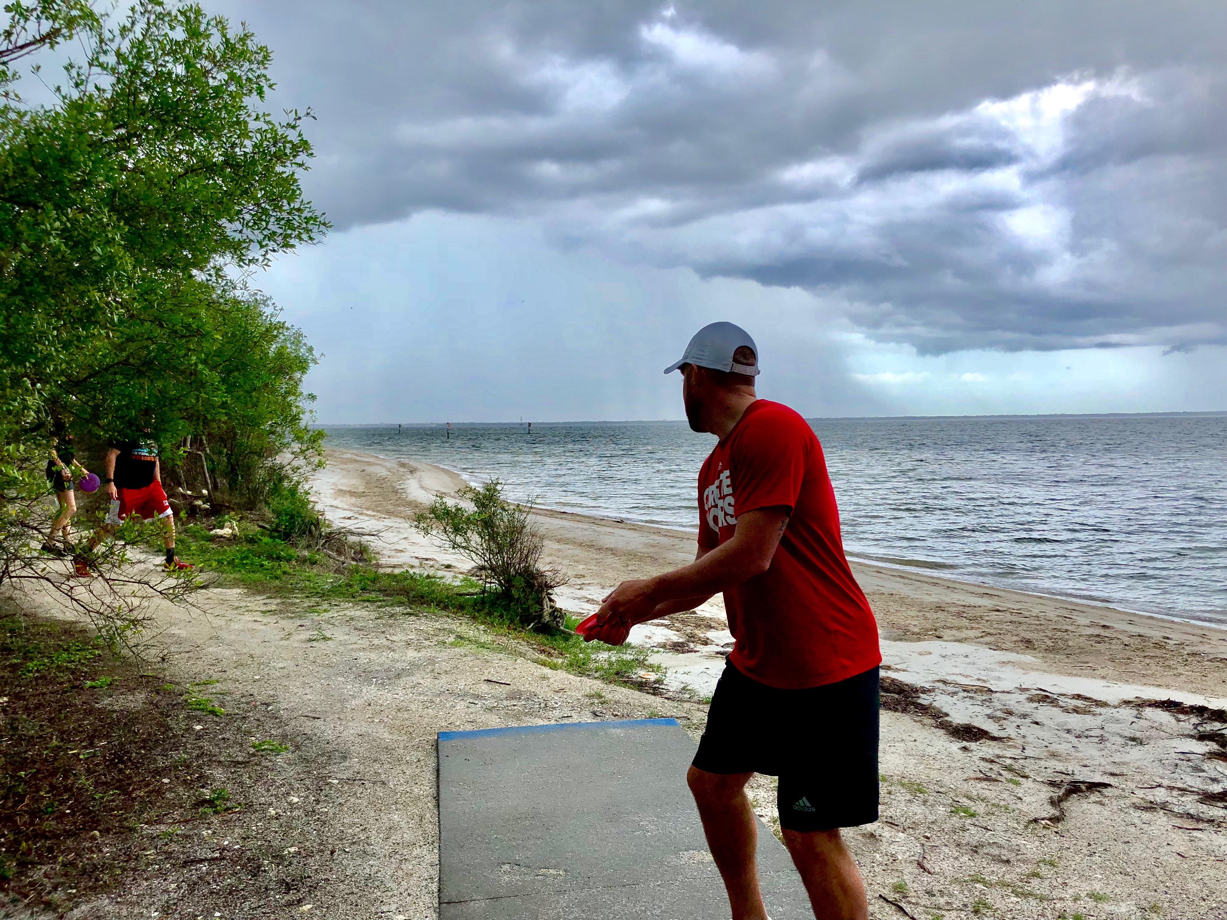 Throwing over the bay into a storm. Picnic Island Tampa FL r/discgolf