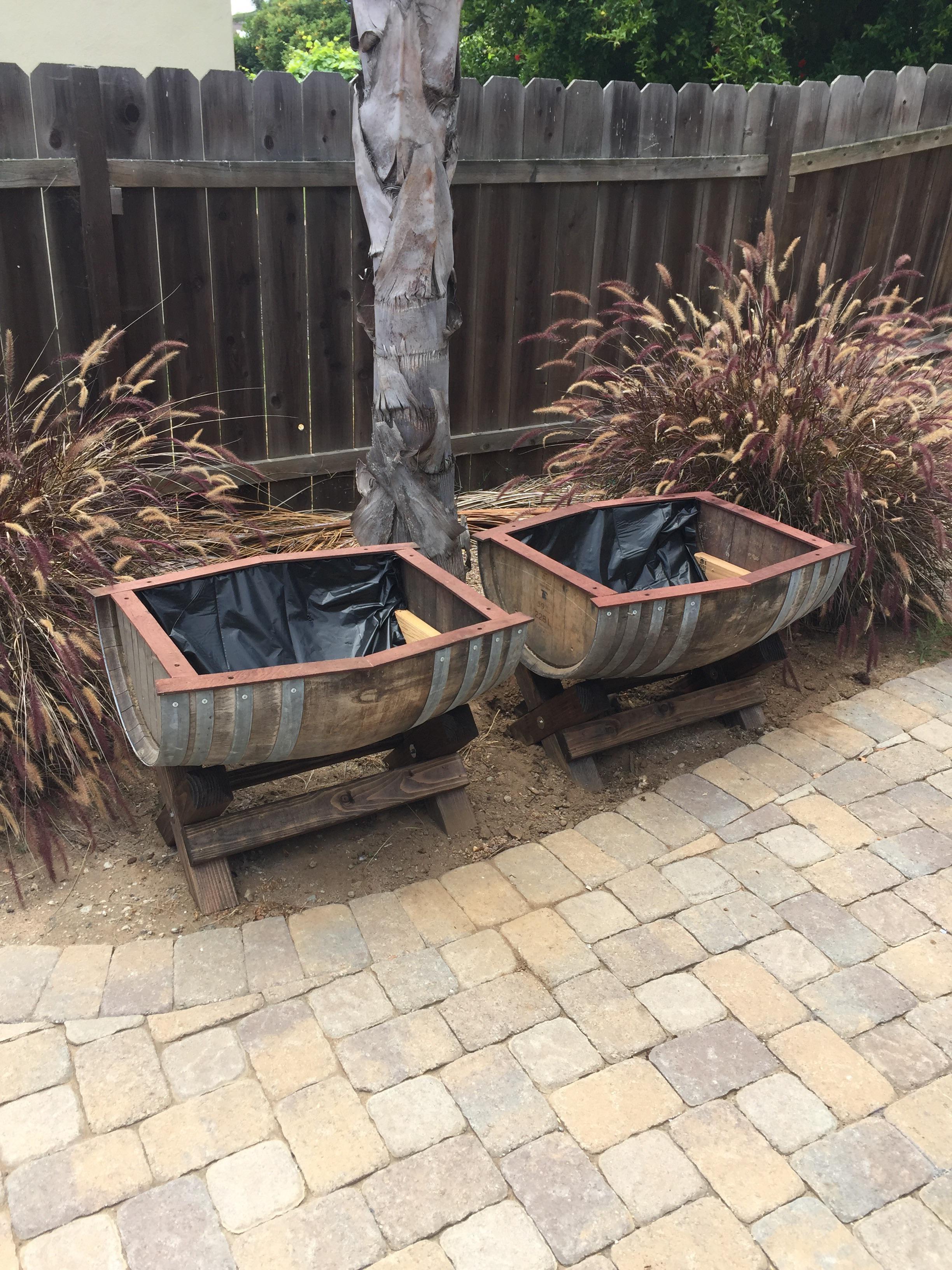 Cut a wine barrel in half and built some leg stands to make planter