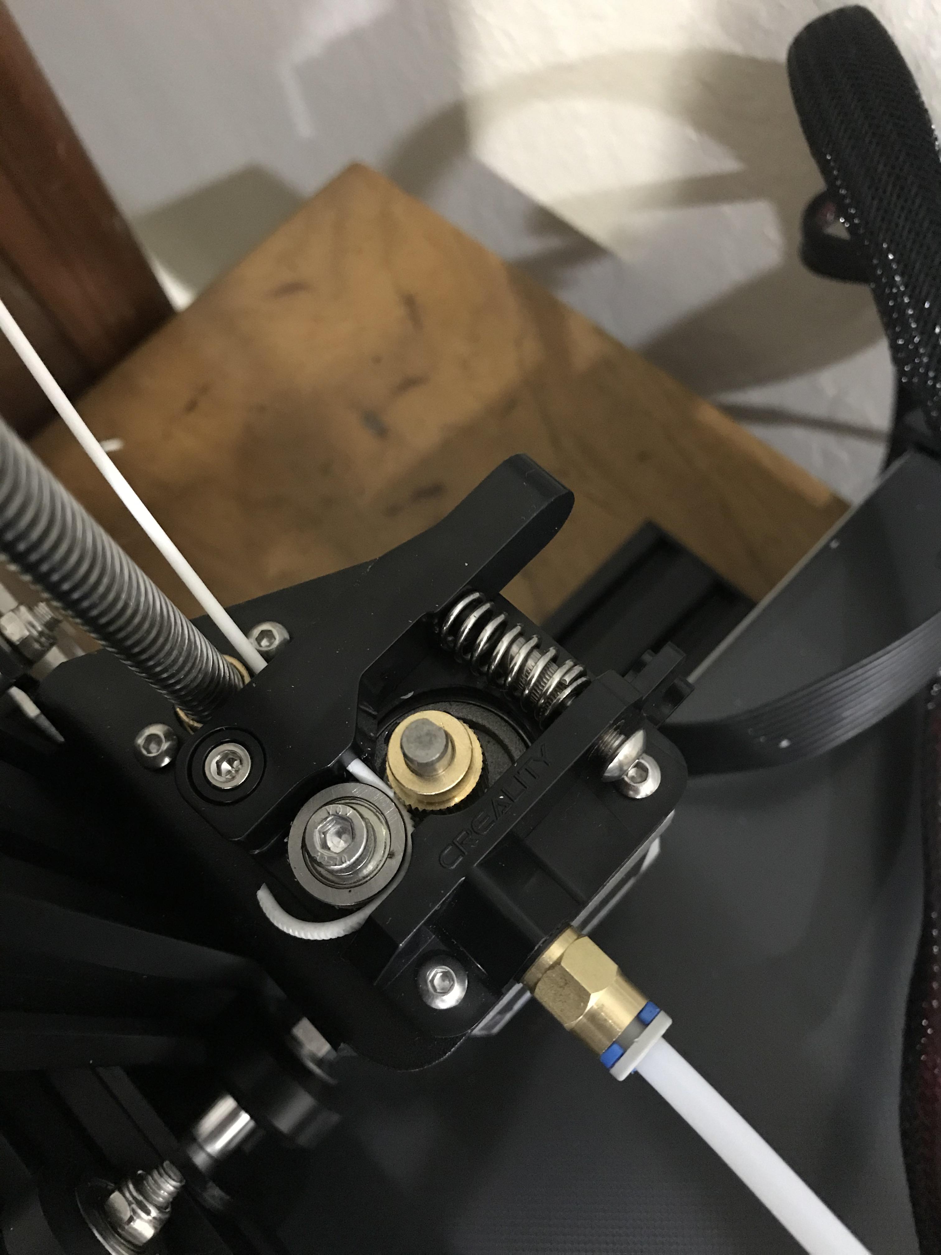 [Ender 3] Filament just curing around gear? How do I get it in the tube