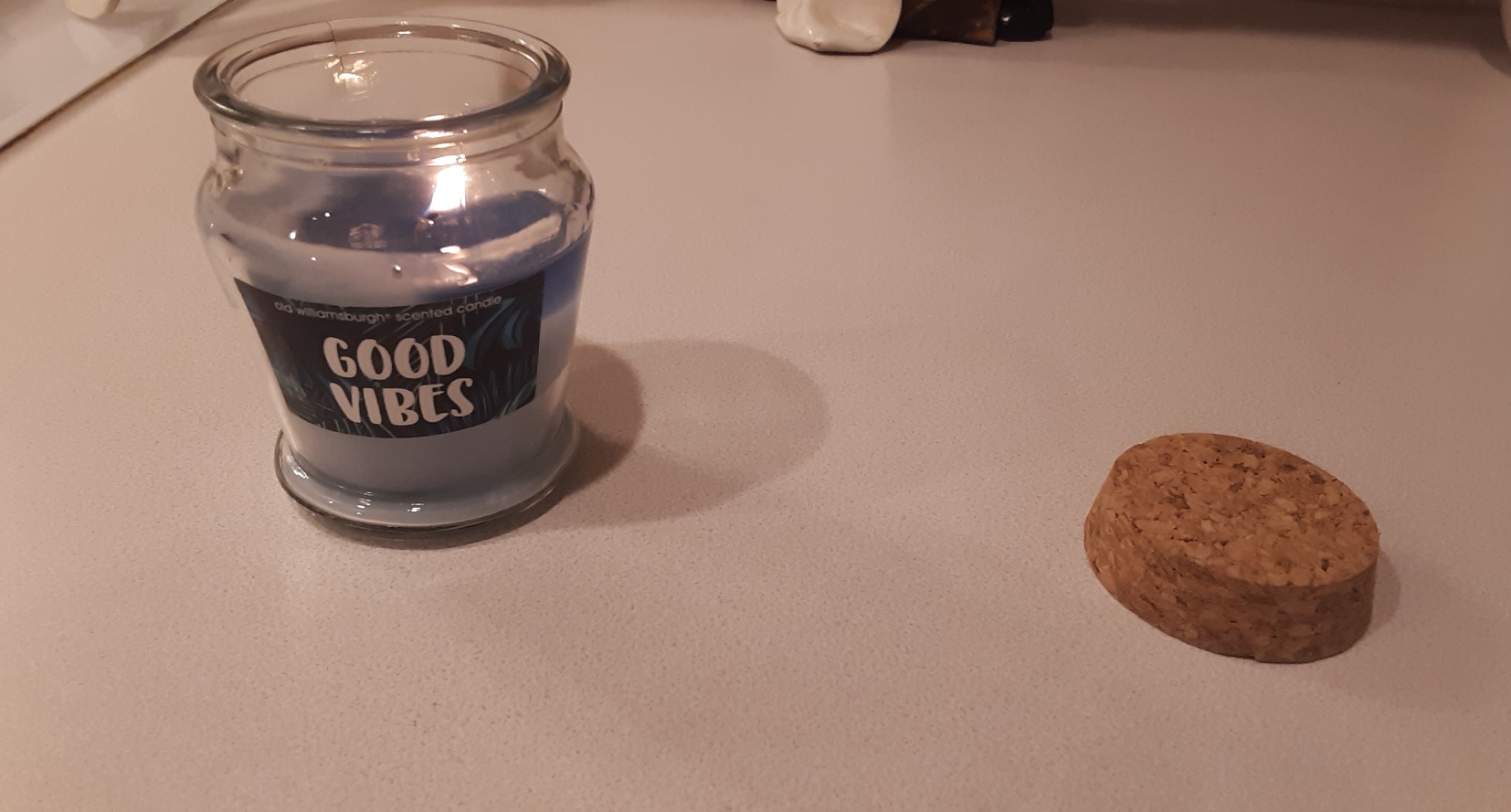 My "Good Vibes" candle from the Dollar Tree, and its flammable cork cap