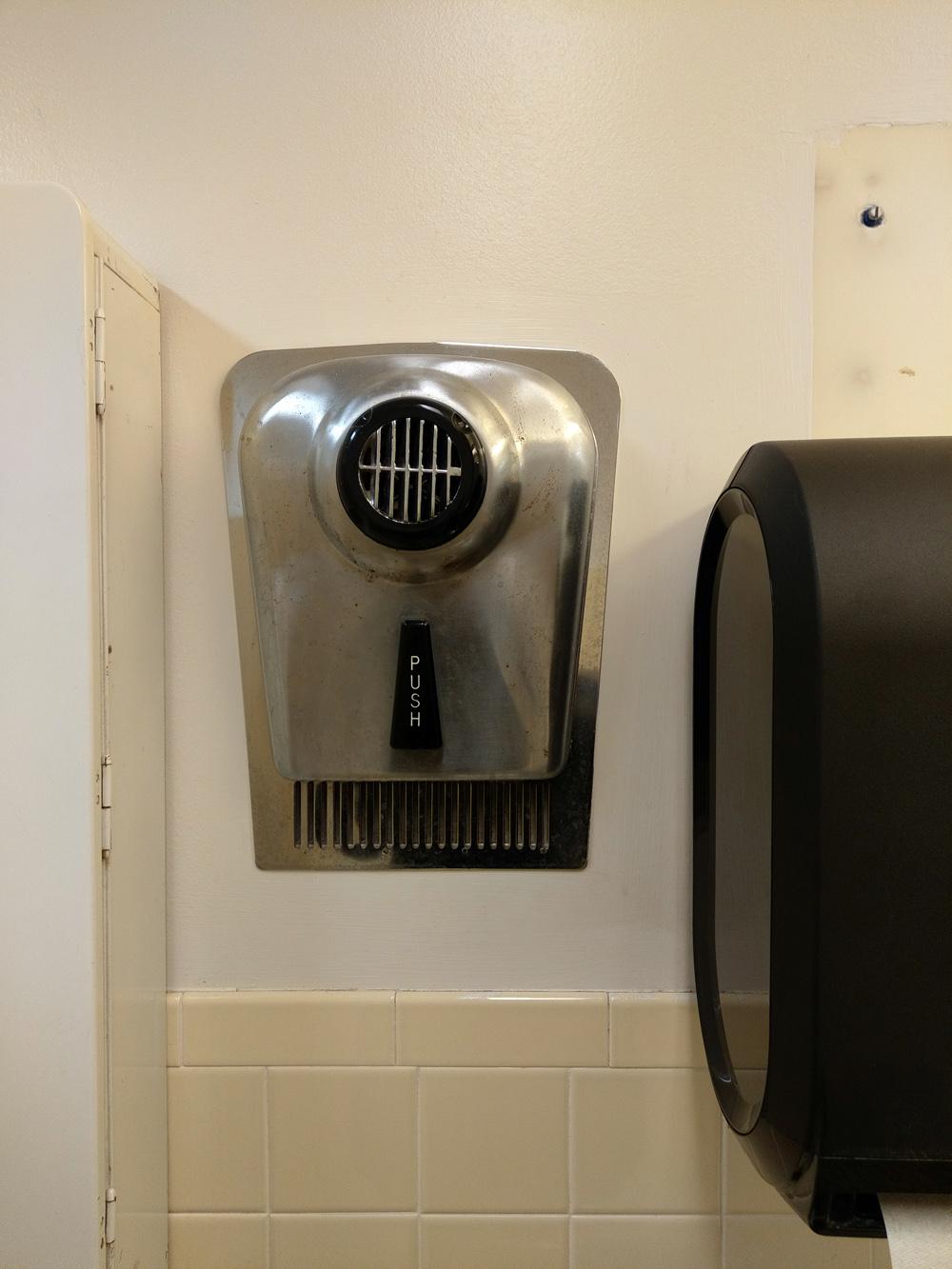 This warmair hand dryer blows air straight at you instead of downward