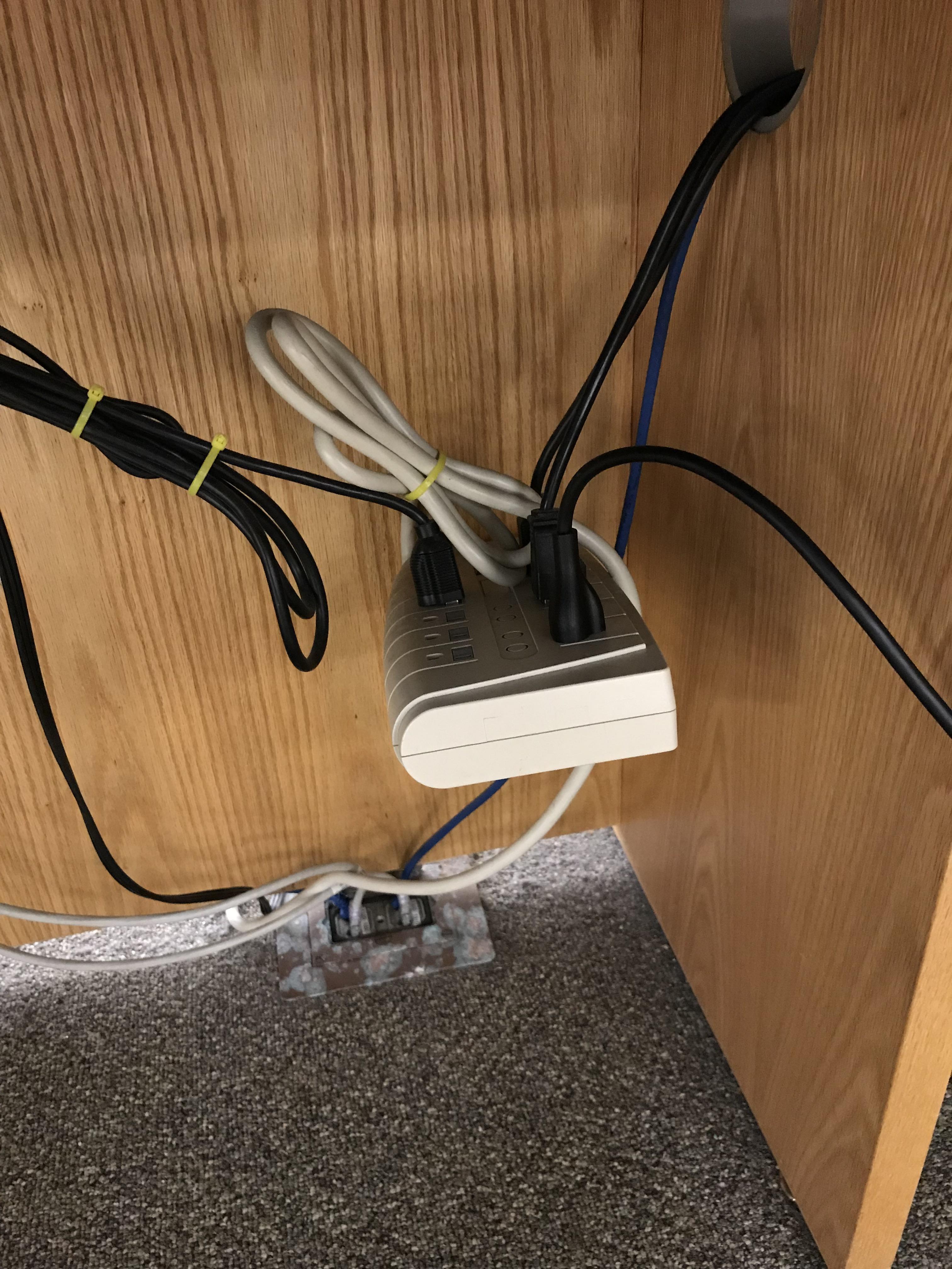 No reason to properly mount the power strip. The plugs can hold it up