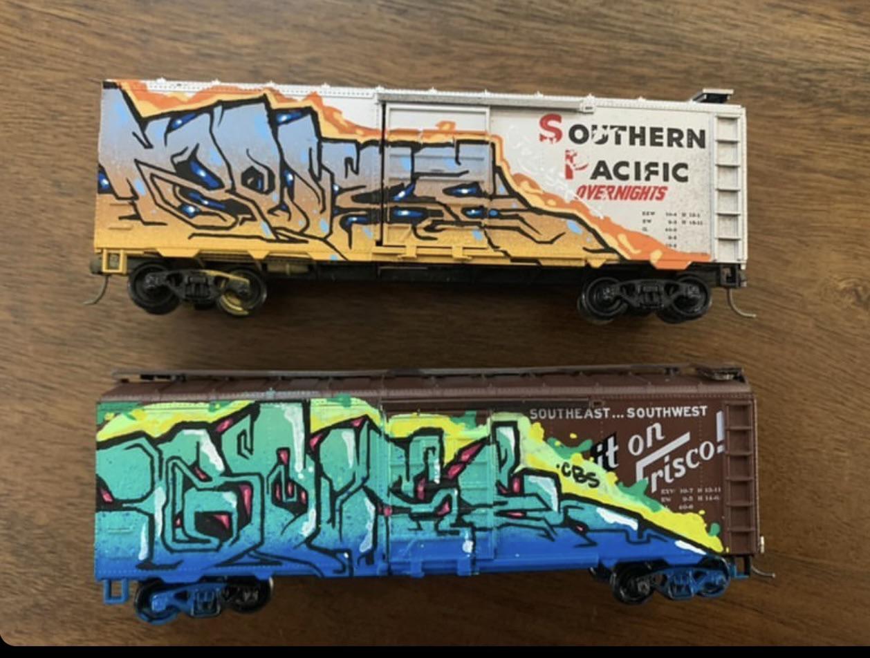 Custom graffiti art on some HO rolling stock r/modeltrains