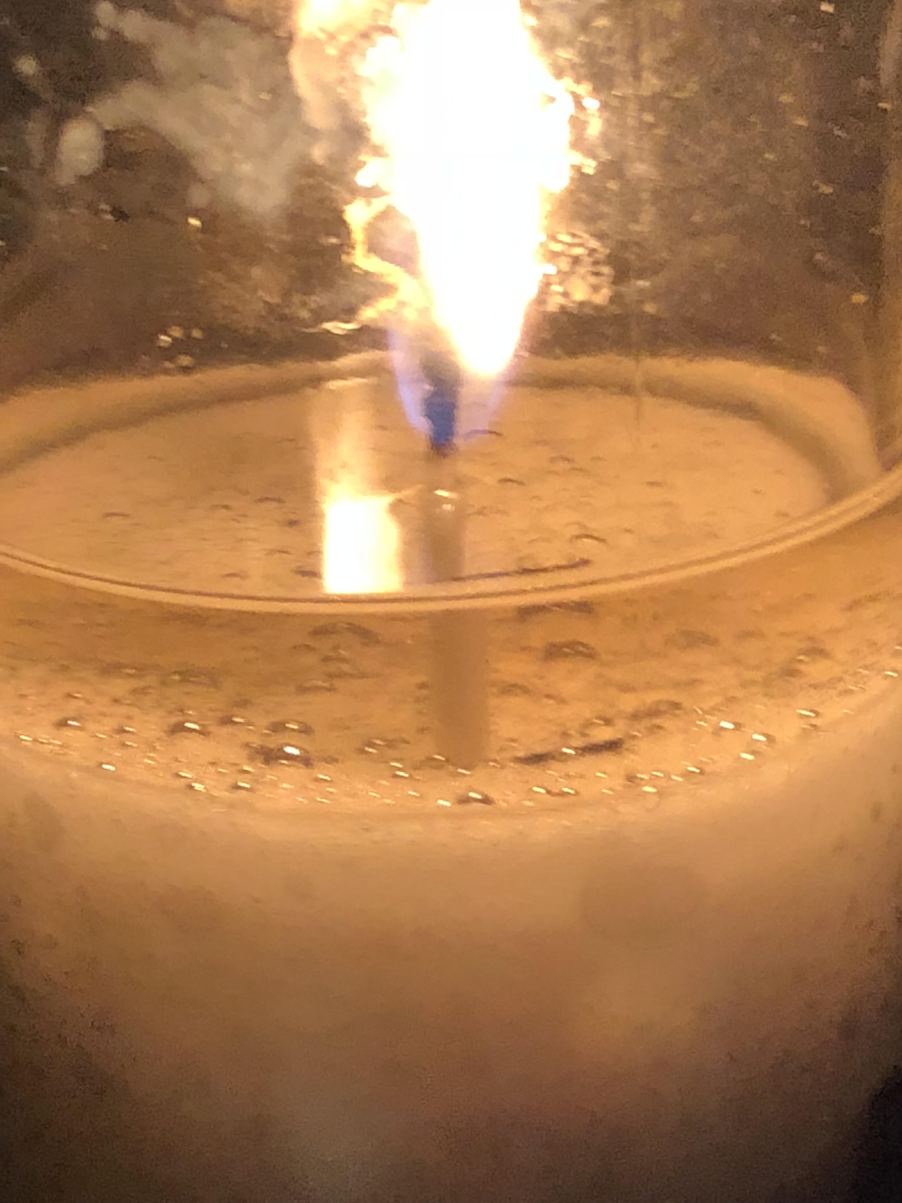 A white candles melted wax from a side view r/mildlyinteresting