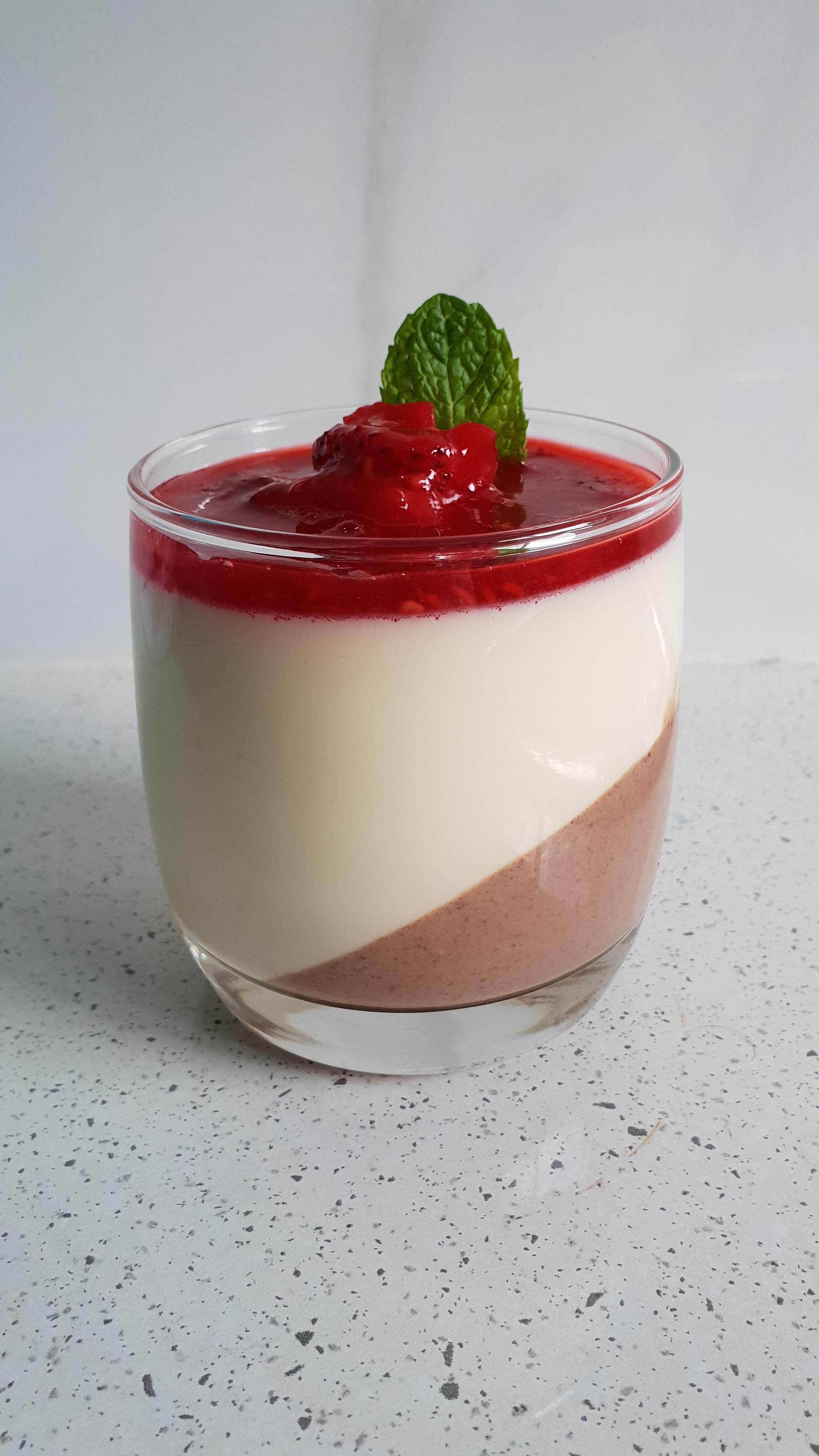 Vanilla panna cotta layered over chocolate panna cotta with berry