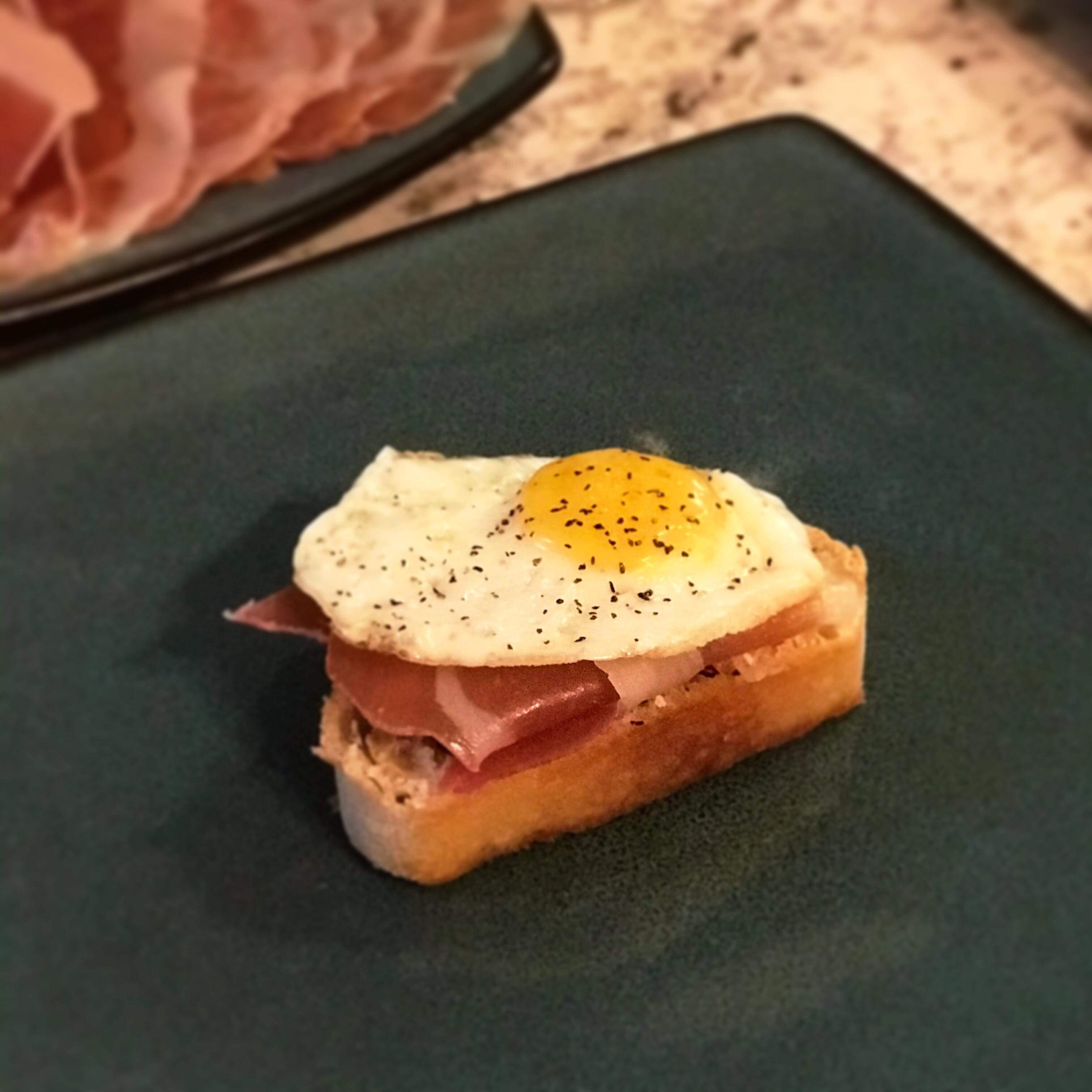 [I ate] over easy quail egg with prosciutto on toast. r/food